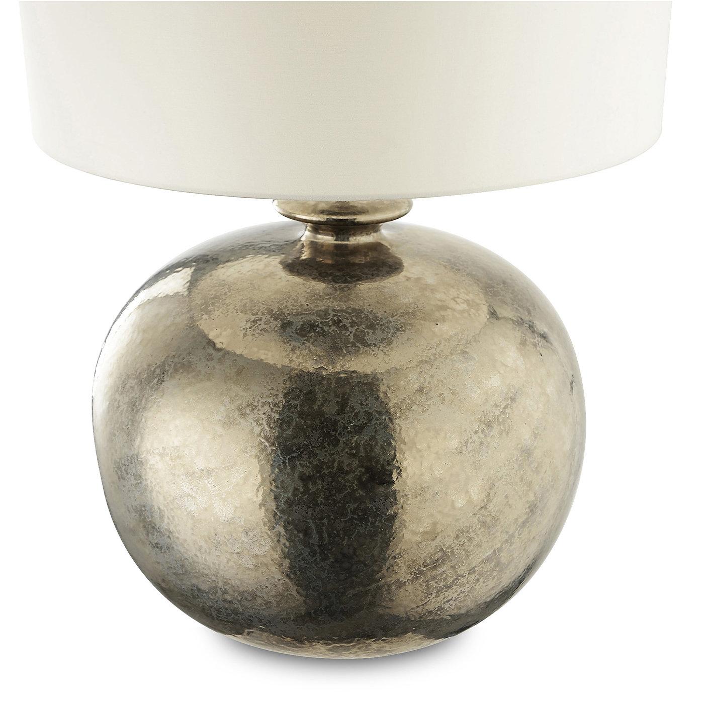 This lovely table lamp in glazed ceramic will be sure to add a touch of sophistication to any room it illuminates. The round body of the lamp is enamelled with a platinum finish that is brushed onto the glazed ceramic surface. The piece is completed