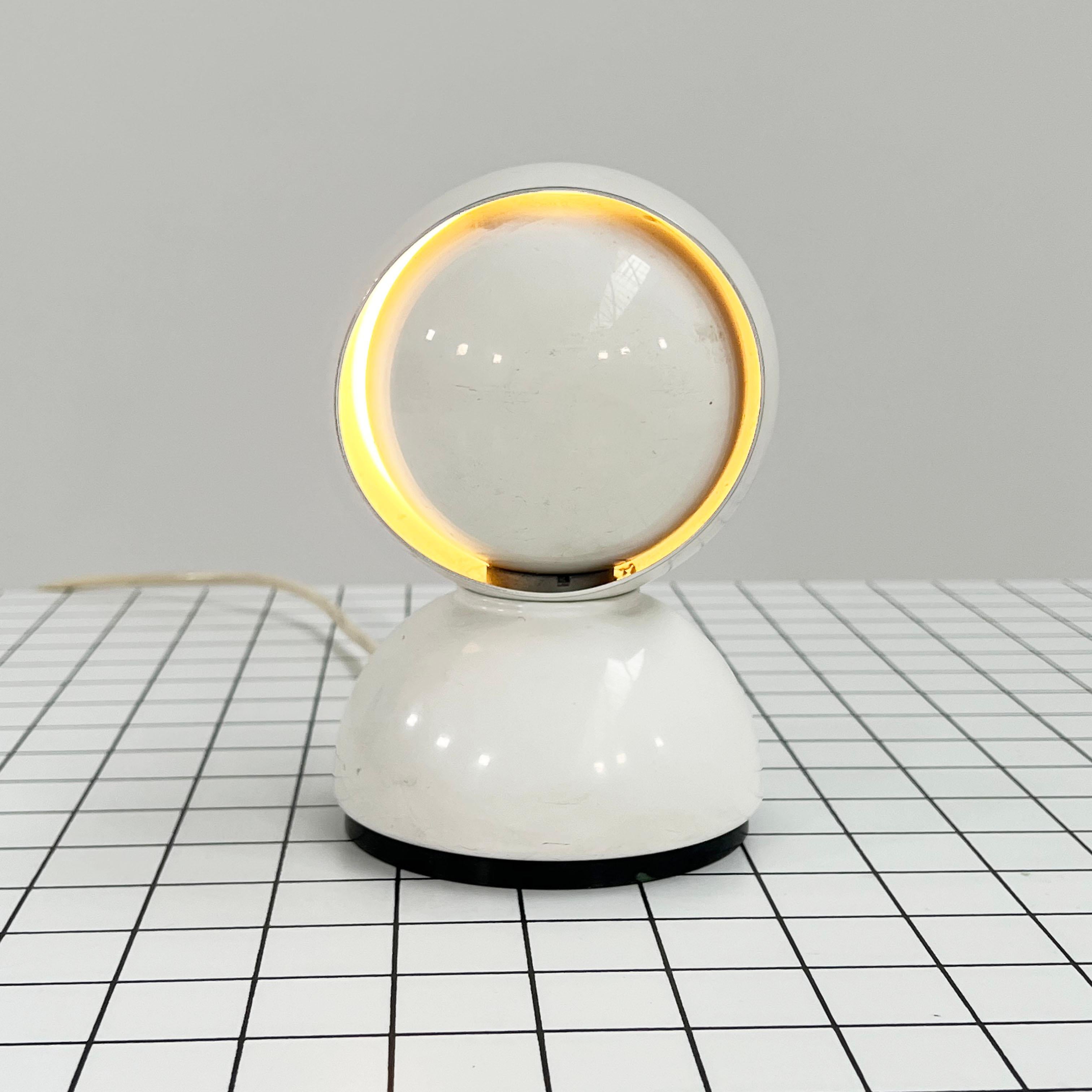 Designer - Vico Magistretti
Producer - Artemide
Model - Eclisse Table Lamp
Design Period - Sixties
Measurements - Width 12 cm x depth 12 cm x height 18.5 cm
Materials - Metal
Color - White
Light wear consistent with age and use. Some scuffs,