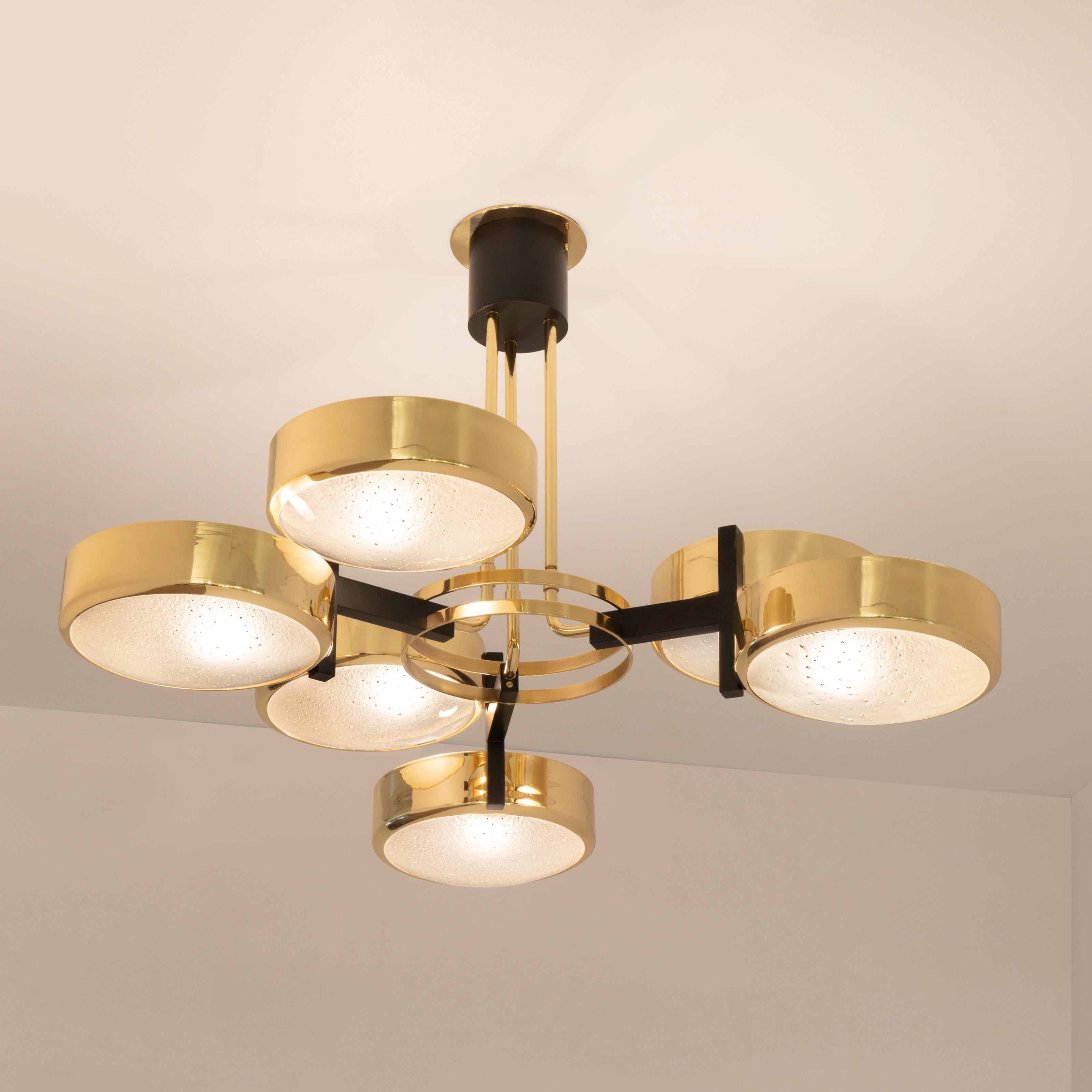 The Eclissi ceiling light is designed around three pairs of eclipsing shades bound by a series of brass rings and a distinctive triple stem. The first images show the fixture in our polished brass finish with black accents-subsequent pictures show