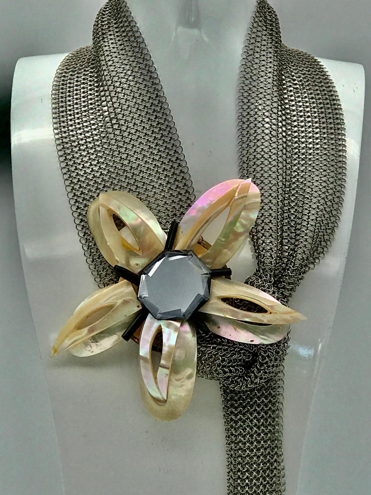 
This Belt/Necklace  from iridescent pink nacre /Turbo Marmoratus shell  has been up-cycled from hand cut and polished pieces, produced during the French Deco period. The forms of the Necklace/Belt are convex parts of the Turbo shell cut as petals,