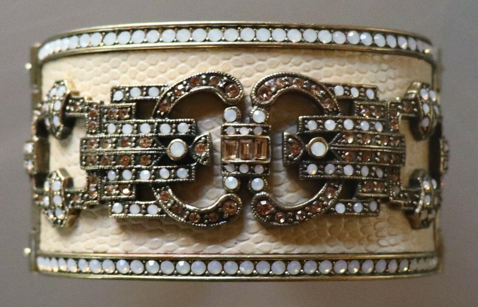 Simply Beautiful Double Hinged Ecru Enamel Cuff Bracelet, outlined in Crystals and center embellished with multi-colored Swarovski Crystals in an ornate design; over embossed Leather. Measuring approx. 1.63” wide x 6.5” inside Circumference x  0.50”