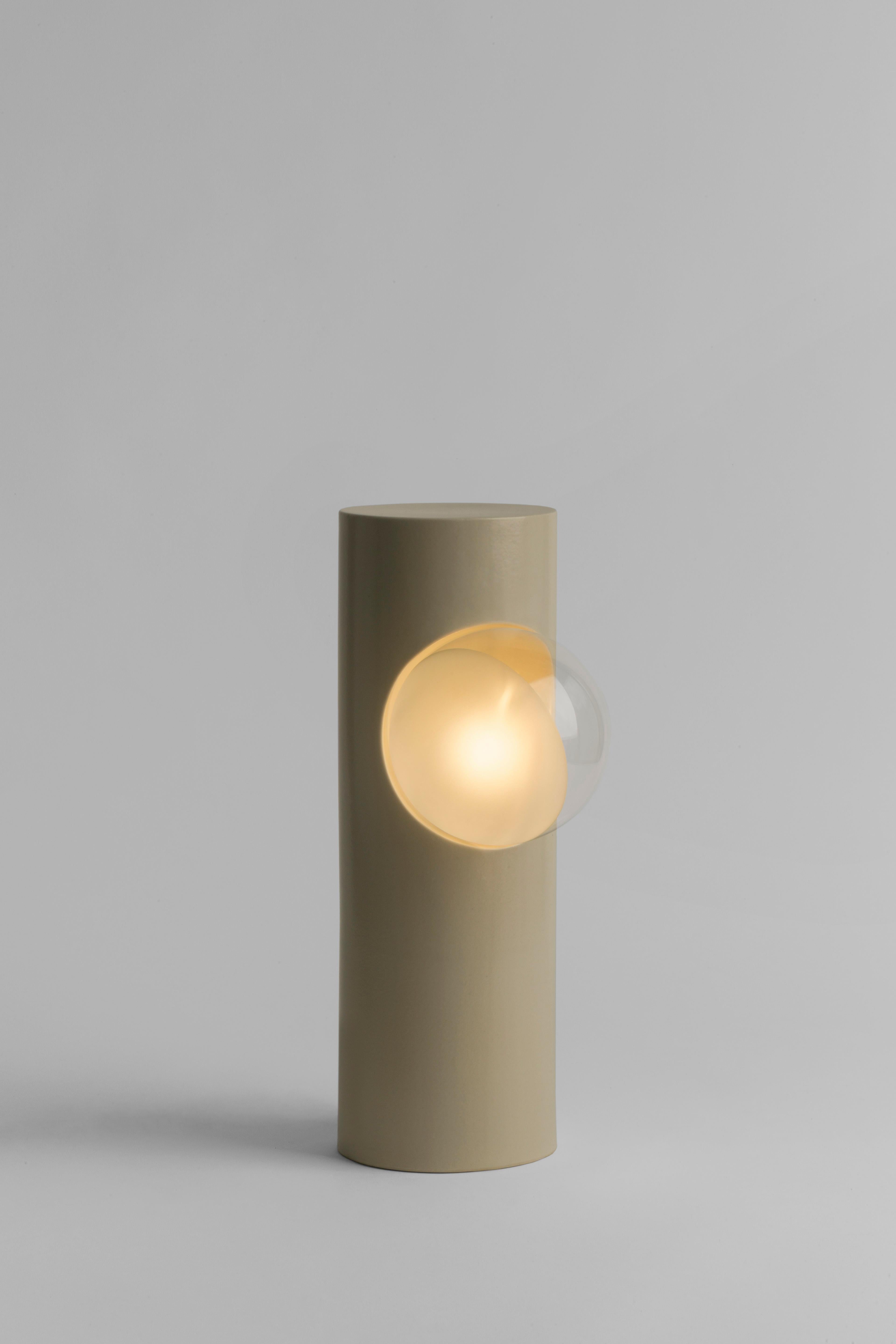 Ecru Semigloss Post Lamp by Subject Bureaux
DImensions: ? 12.7 x H 38 cm
Materials: Handmade Slip Cast Stoneware, Glass.

The Post Lamp was derived from the exercise of consistently being aware of ones environment. By being curious of the things
