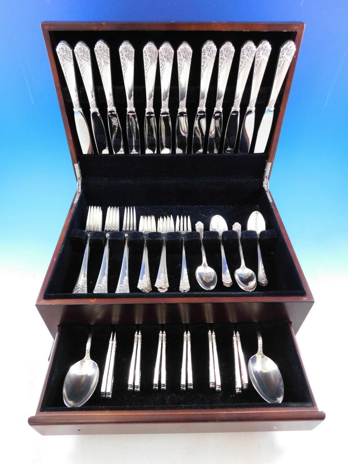 Dinner size Ecstacy by Amston c1951 Sterling silver Flatware set with a sweeping floral design, 62 pieces. This set includes:

12 Dinner Size Knives, 9 3/4