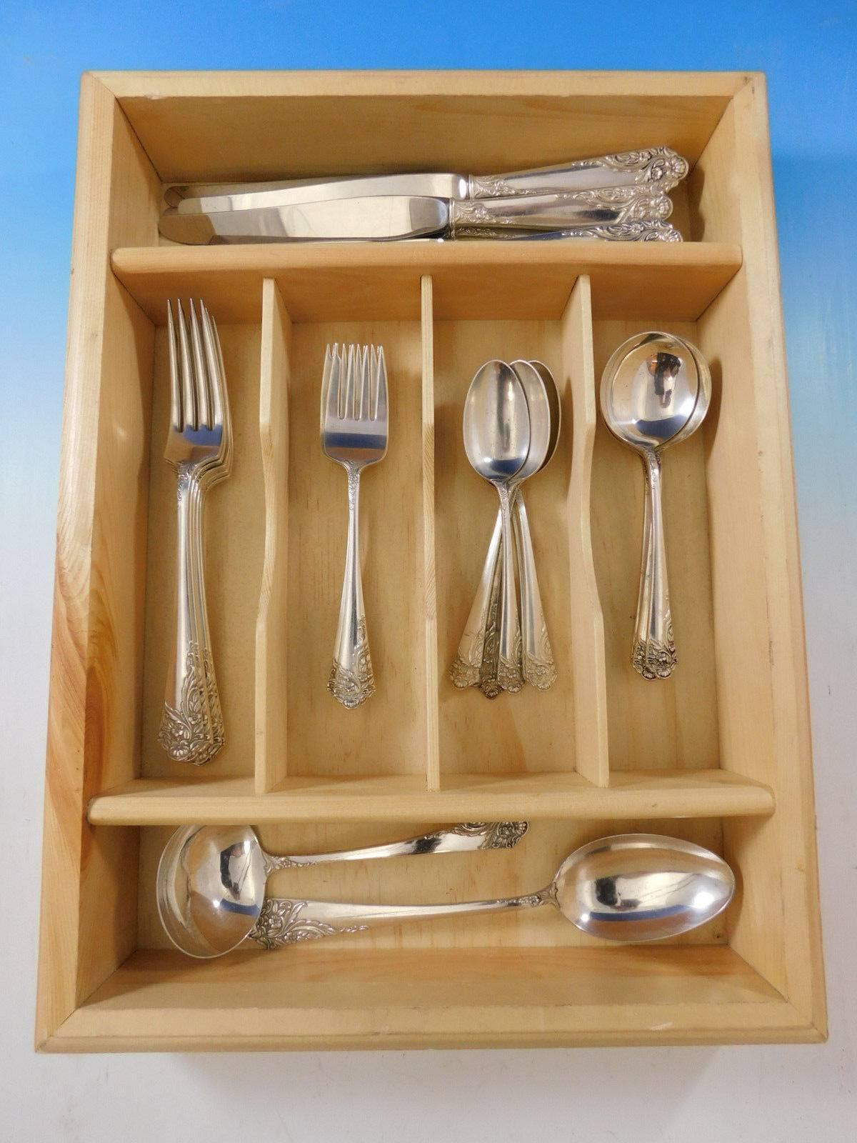 Dinner size Ecstasy by Amston circa 1951 sterling silver flatware set with a sweeping floral design, 32 pieces. Great starter set! This set includes:

Six dinner size knives, 9 3/4