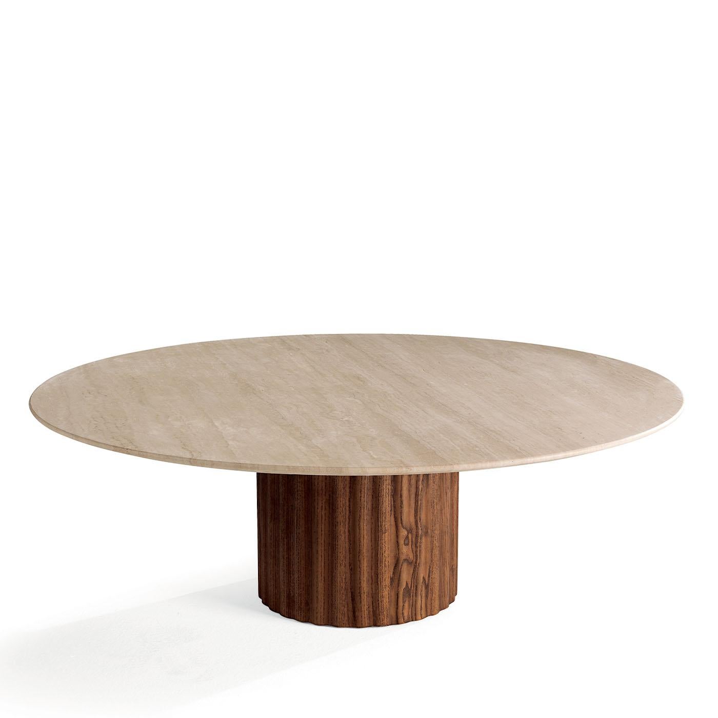 A sophisticated addition to elegant modern interiors, this coffee table boasts harmoniously distributed volumes enhanced by natural materials. A wide round top in Travertine marble gets sustained by a sturdy bronzed metal frame in turn fitted to a