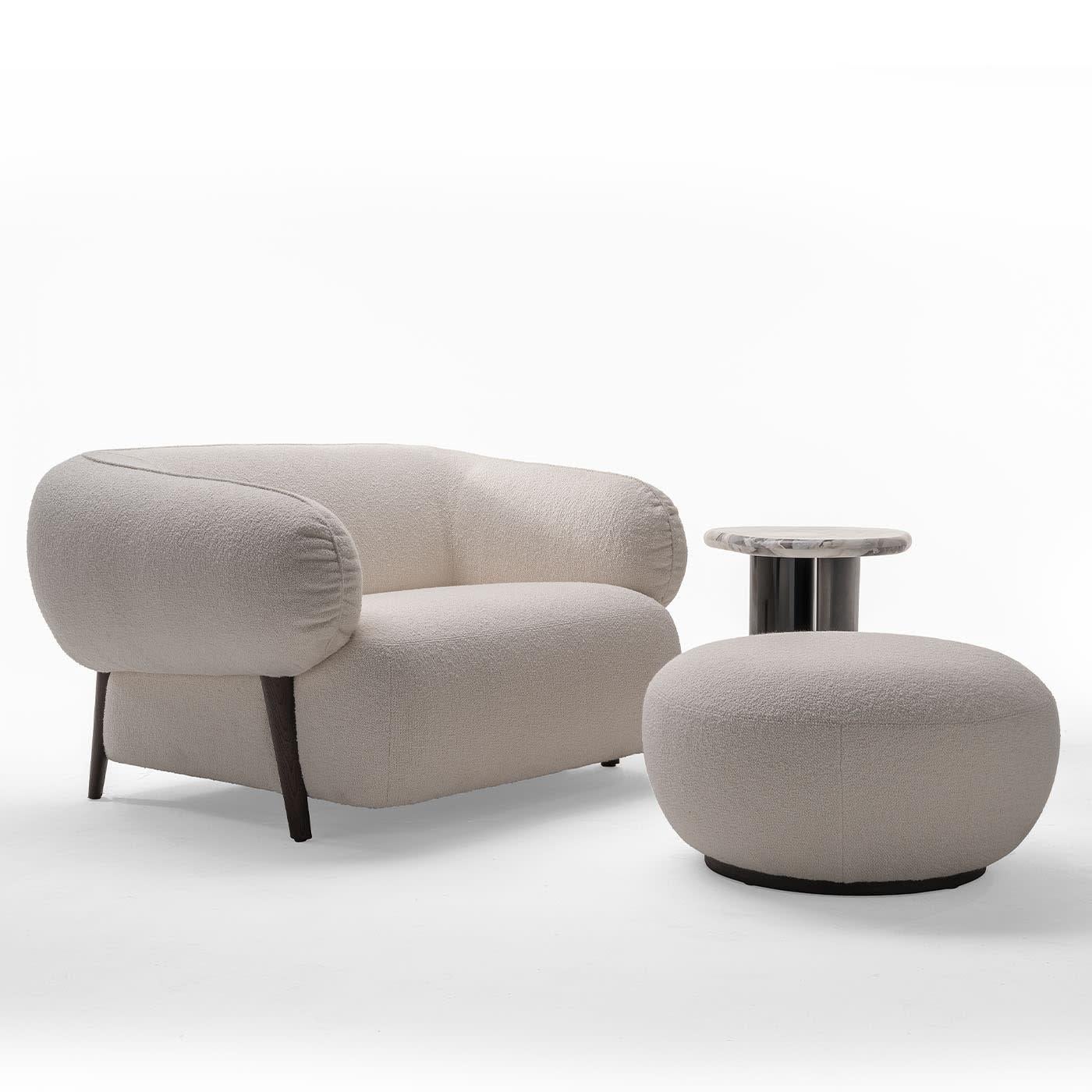 Delicate and plush, this pouf makes for a sophisticated addition to modern and contemporary-style interiors. A pleasant tactile feel is ensured by a soft boucle of white fabric that envelops the entire richly stuffed seat promising impeccable