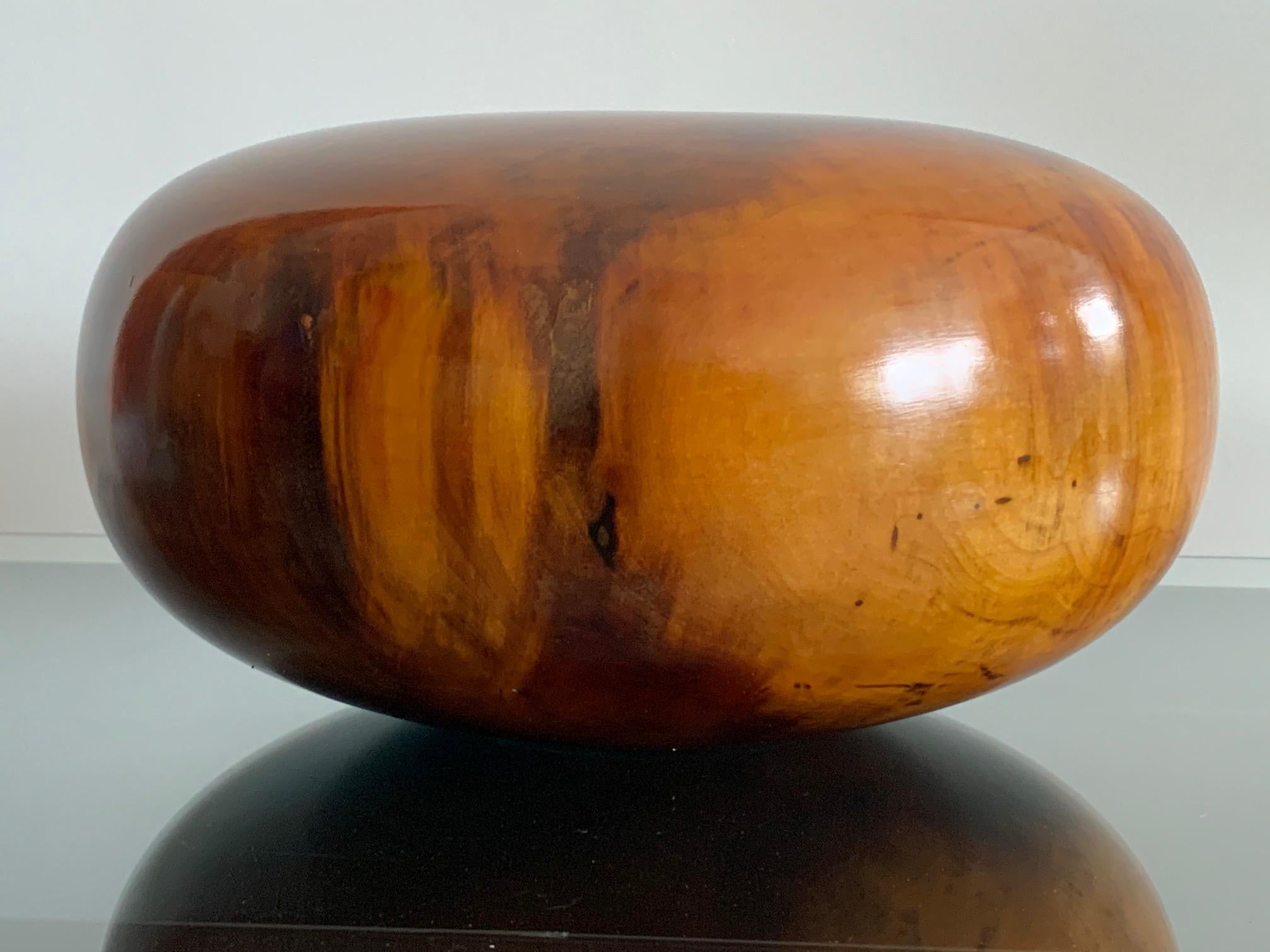 A unique and rare turned bowl by Ed Moulthrop. Made of figured tulipwood and finished in reflective gloss the bowl has great presence and an aura of mystery. Very painterly effect achieved by chiaroscuro in natural wood graining, while remaining a