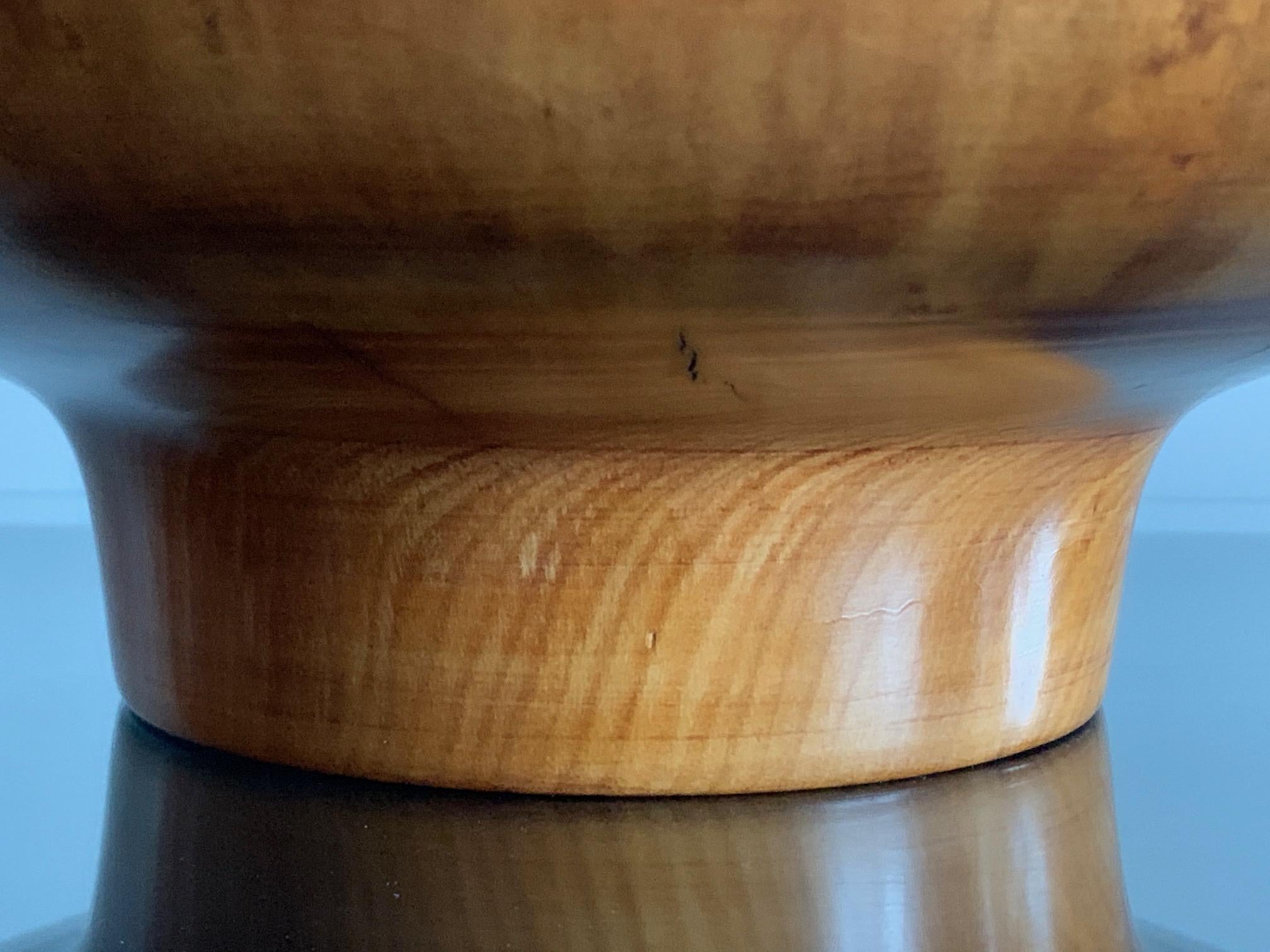 A unique and rare turned bowl by Ed Moulthrop. Made of figured tulipwood and finished in reflective gloss the bowl has great presence and an aura of mystery. Ed Moulthrop is a master at letting the wood reveal it's character and speak for itself.
