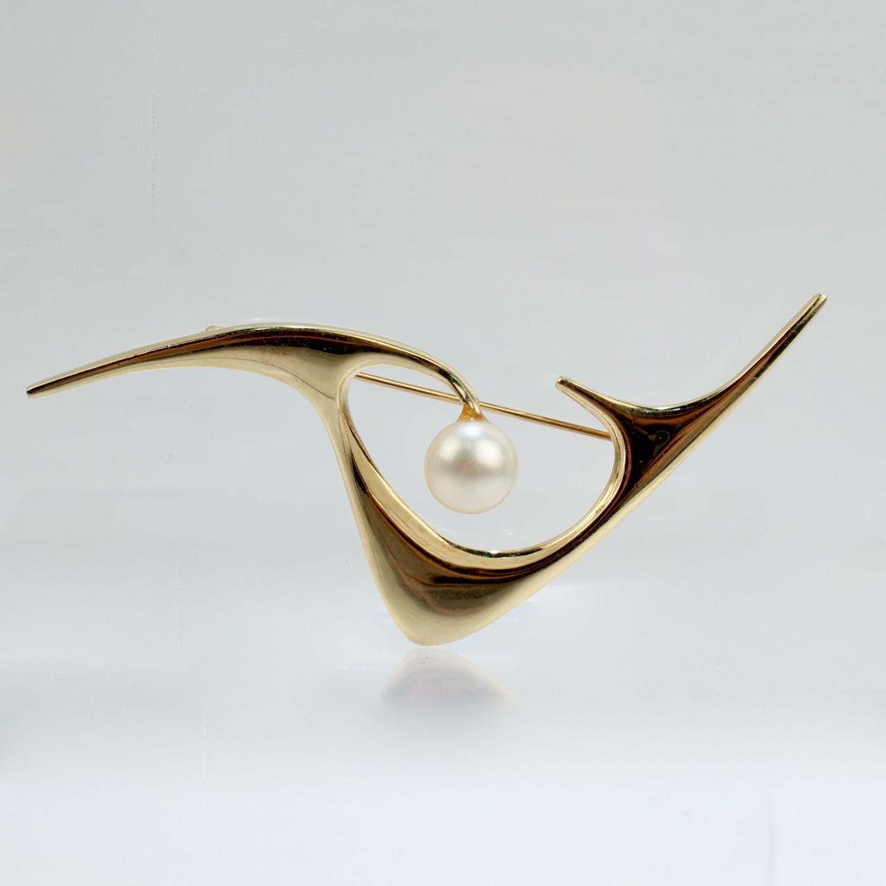 A very fine brooch by Ed Wiener.

Additional Details:
In 14k gold and set with cultured round white pearl.

Great Modernism from one of New York City's most important Mid-Century jewelry makers!

Date:
Mid-20th Century

Overall Condition:
It is in