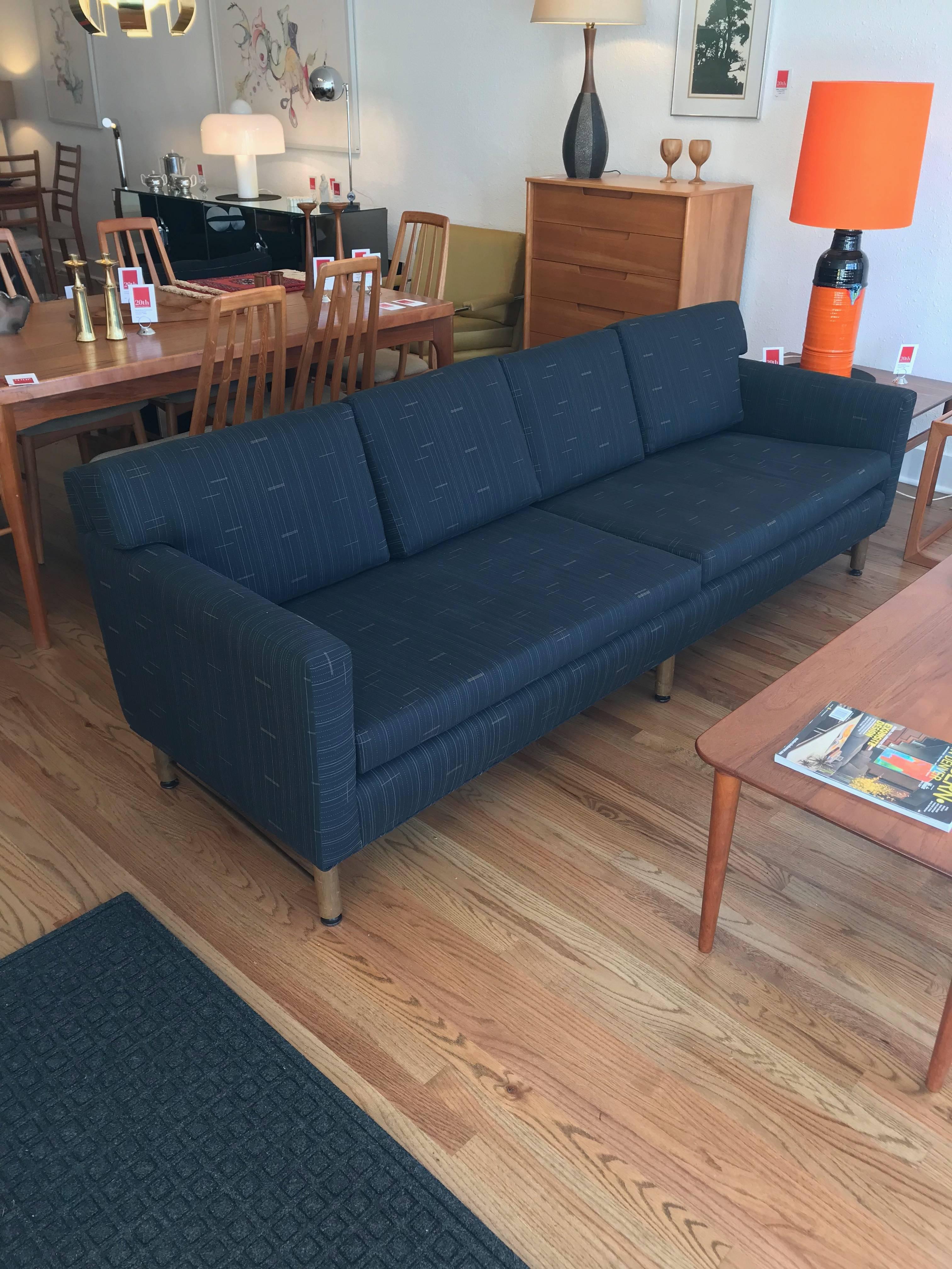 This handsome sofa, designed for Dunbar by Ed Wormley, has been reupholstered in a light black/charcoal Maharam fabric with fine attention to detail.  Zippered cushions remove to reveal a button-tufted back.

Model 5138, circa 1950s.  Poly/cotton