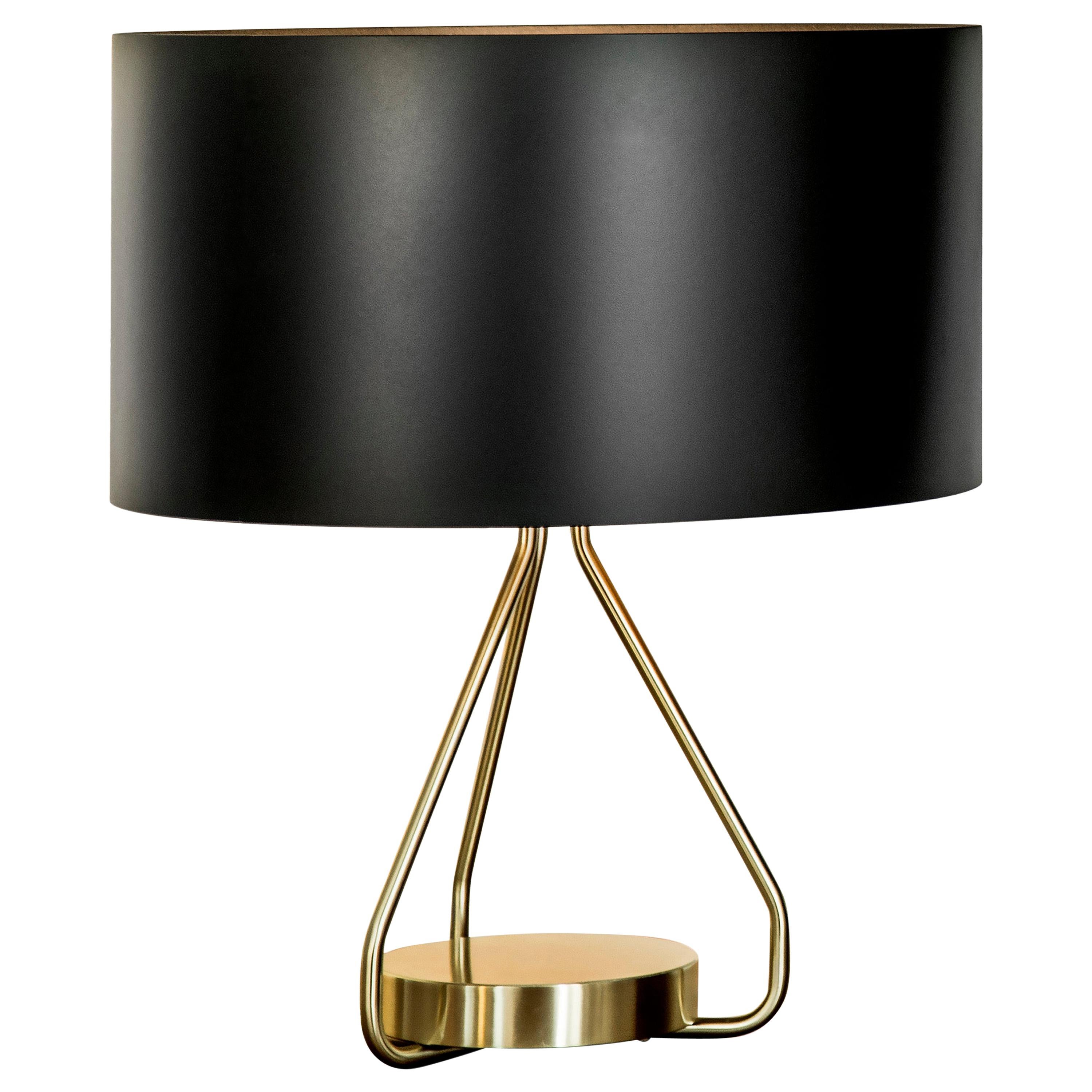 Table lamp with black paint lightshade, brushed brass structure and solid brushed brass base.