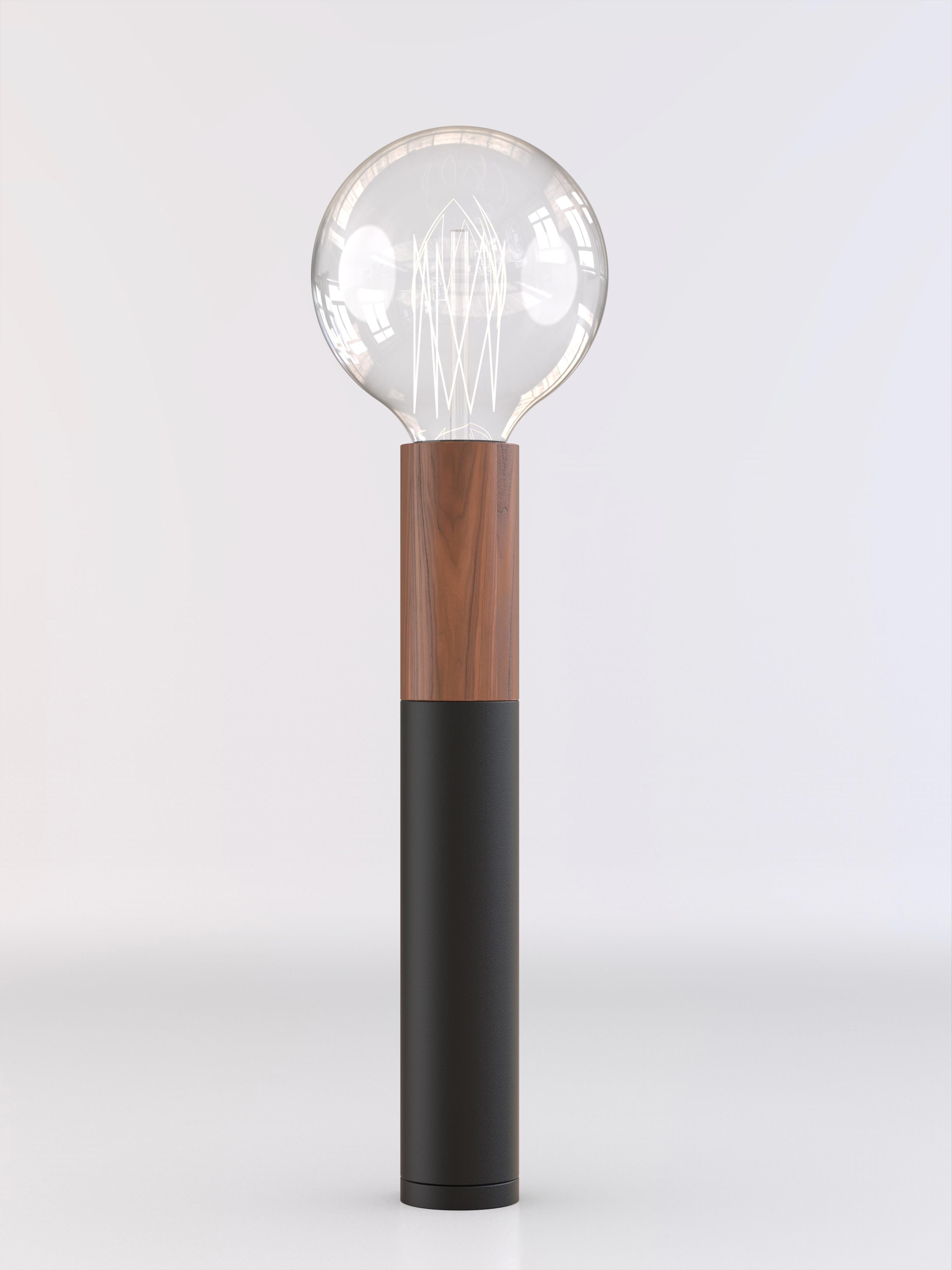 Table lamp with natural wood and black paint structure.