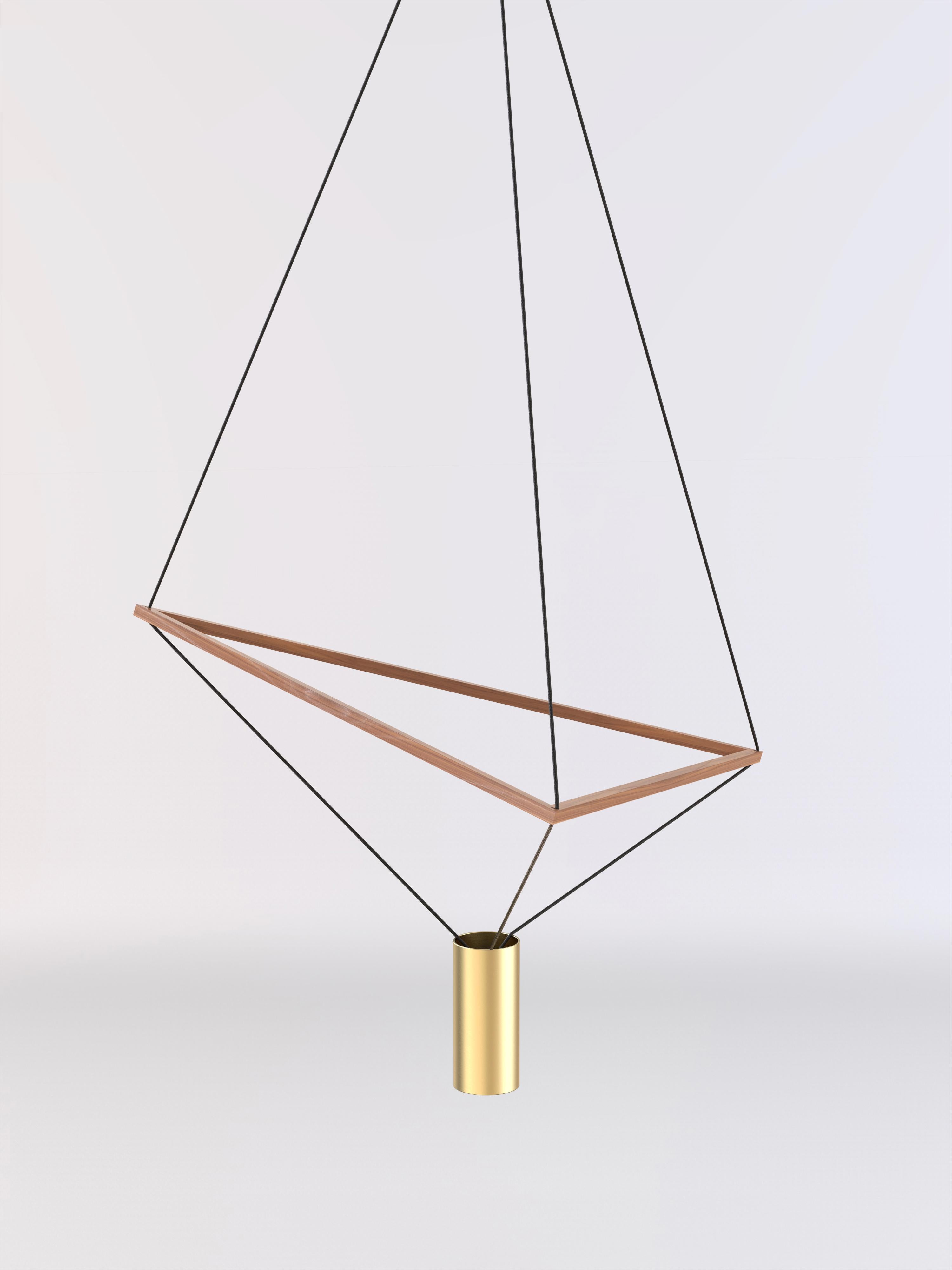 Ceiling lamp with natural wood structure and brushed brass lampshade.
The wooden triangular structure can be freely tilted allowing the lamp's shape to generate multiple geometrical forms.