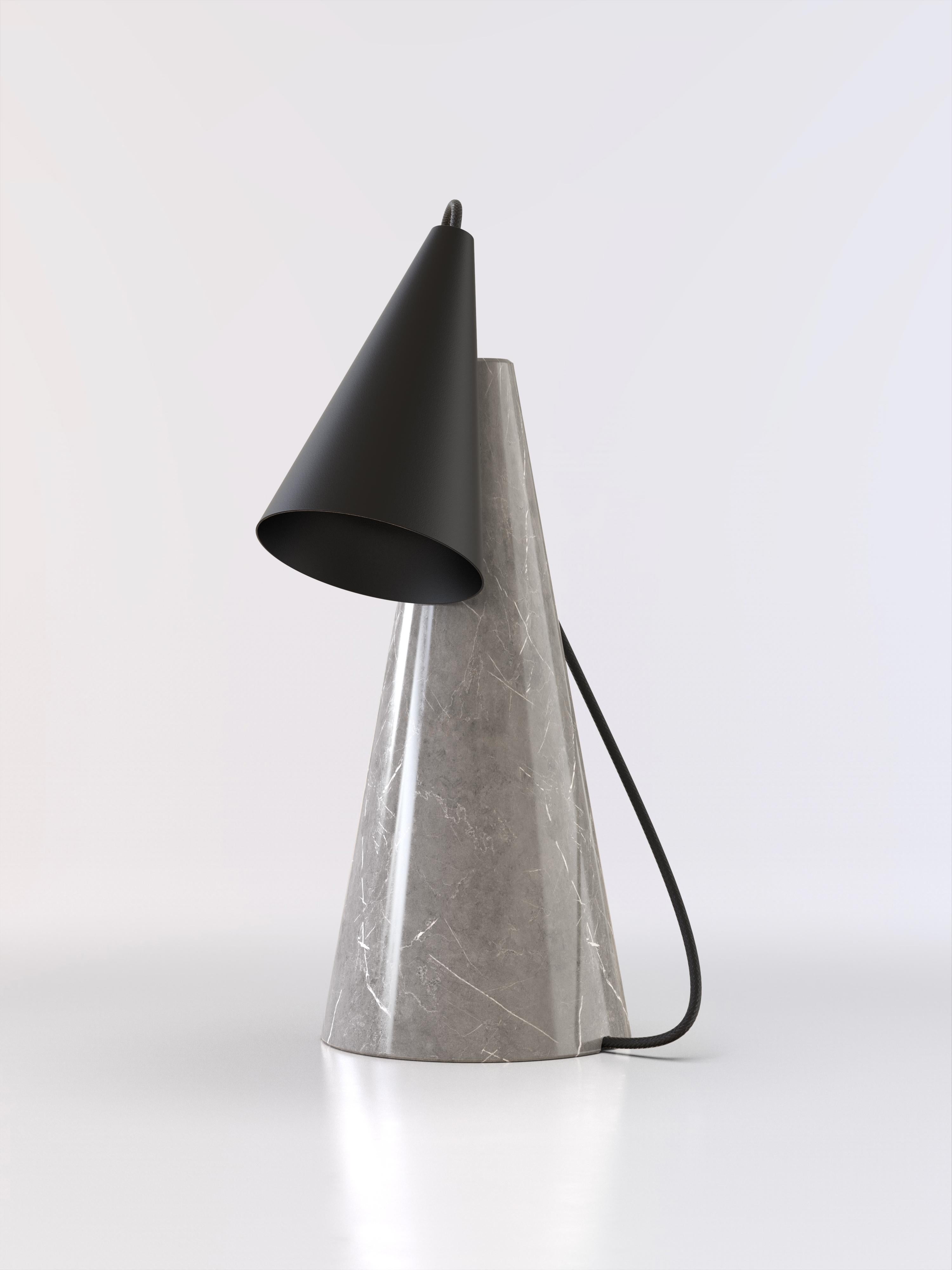 Table lamp with grey stone base and conic black paint lightshade.