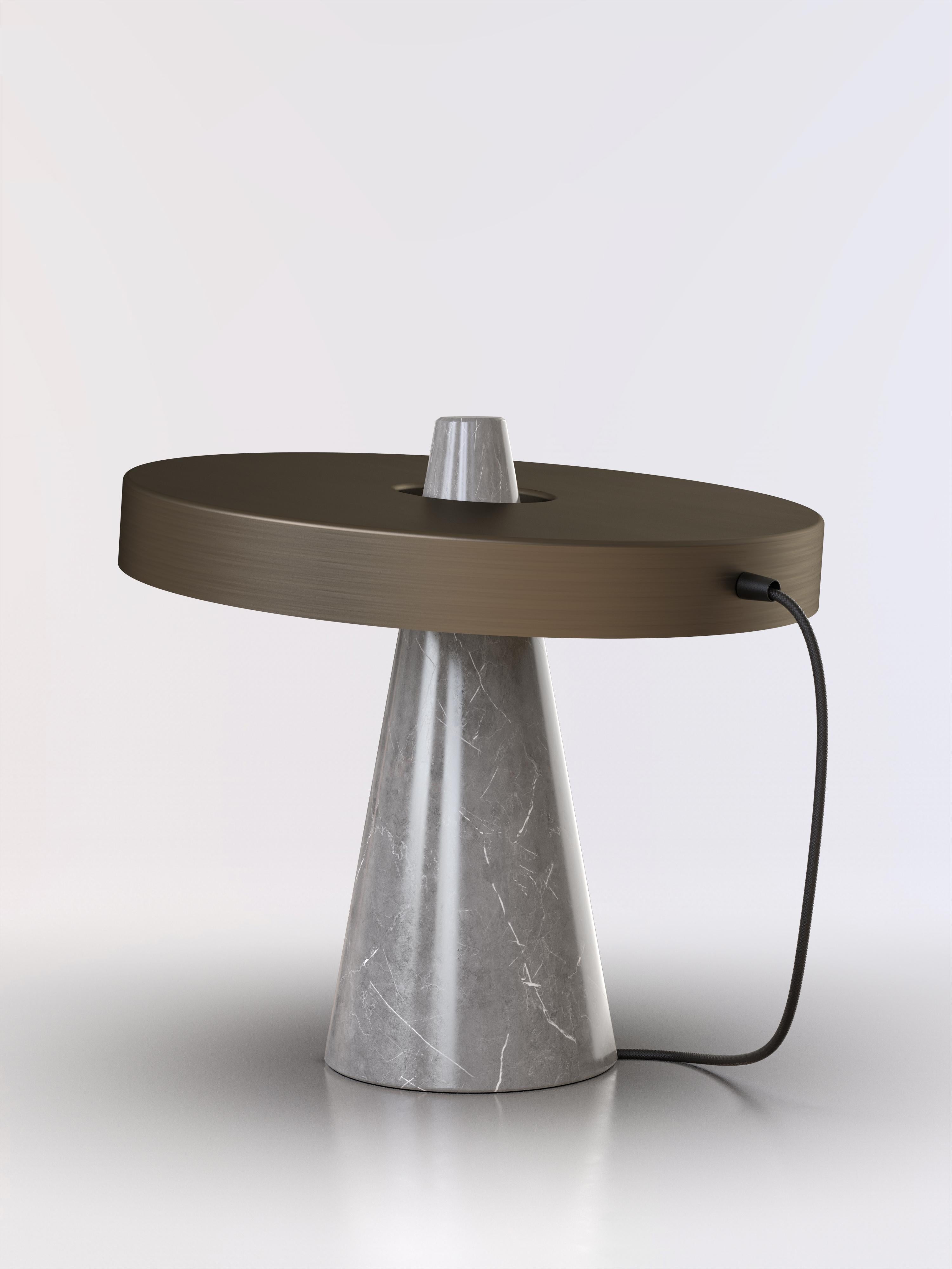 Table lamp with grey stone base and bronze lightshade.
The light shade is disconnected from the stone base and free to tilt, allowing multiple change of styles.
