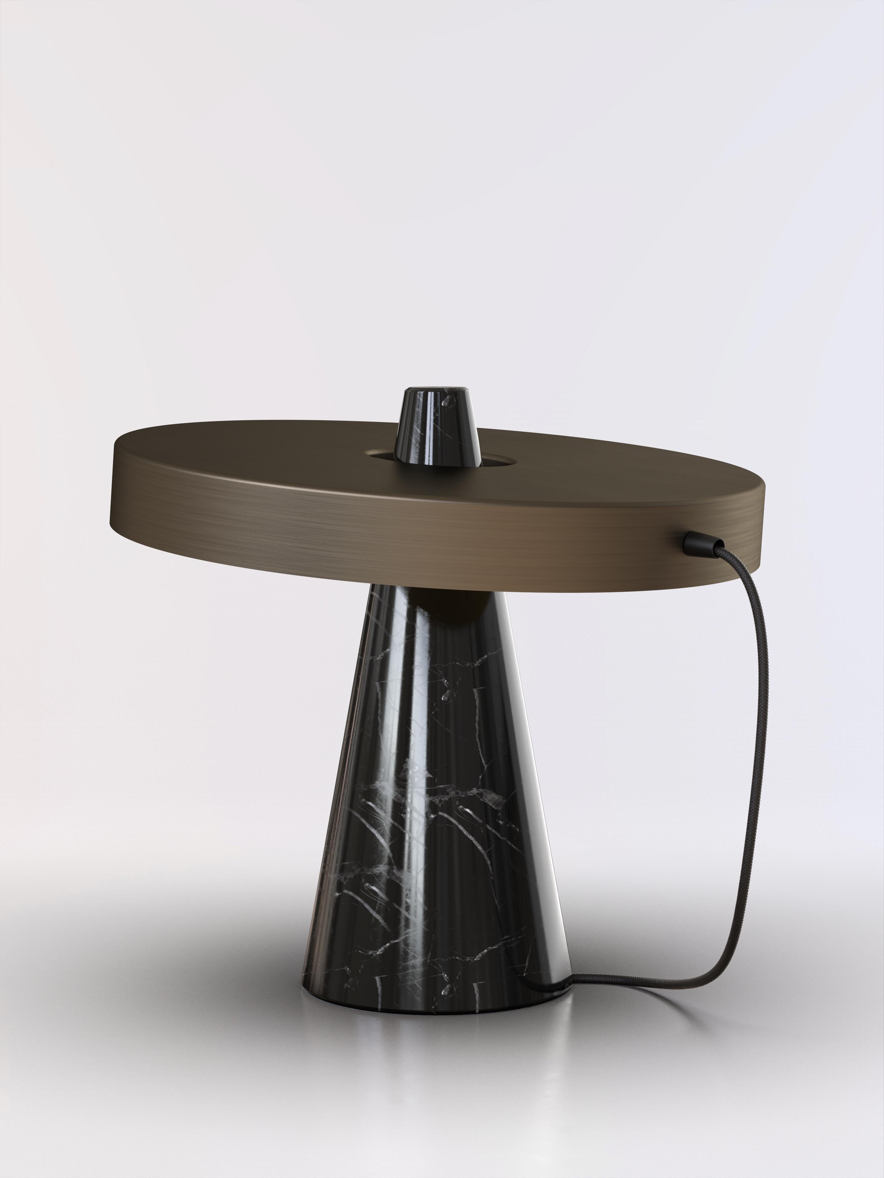 Table lamp with Marquinha black stone base and bronze lightshade.
The light shade is disconnected from the stone base and free to tilt, allowing multiple change of styles.