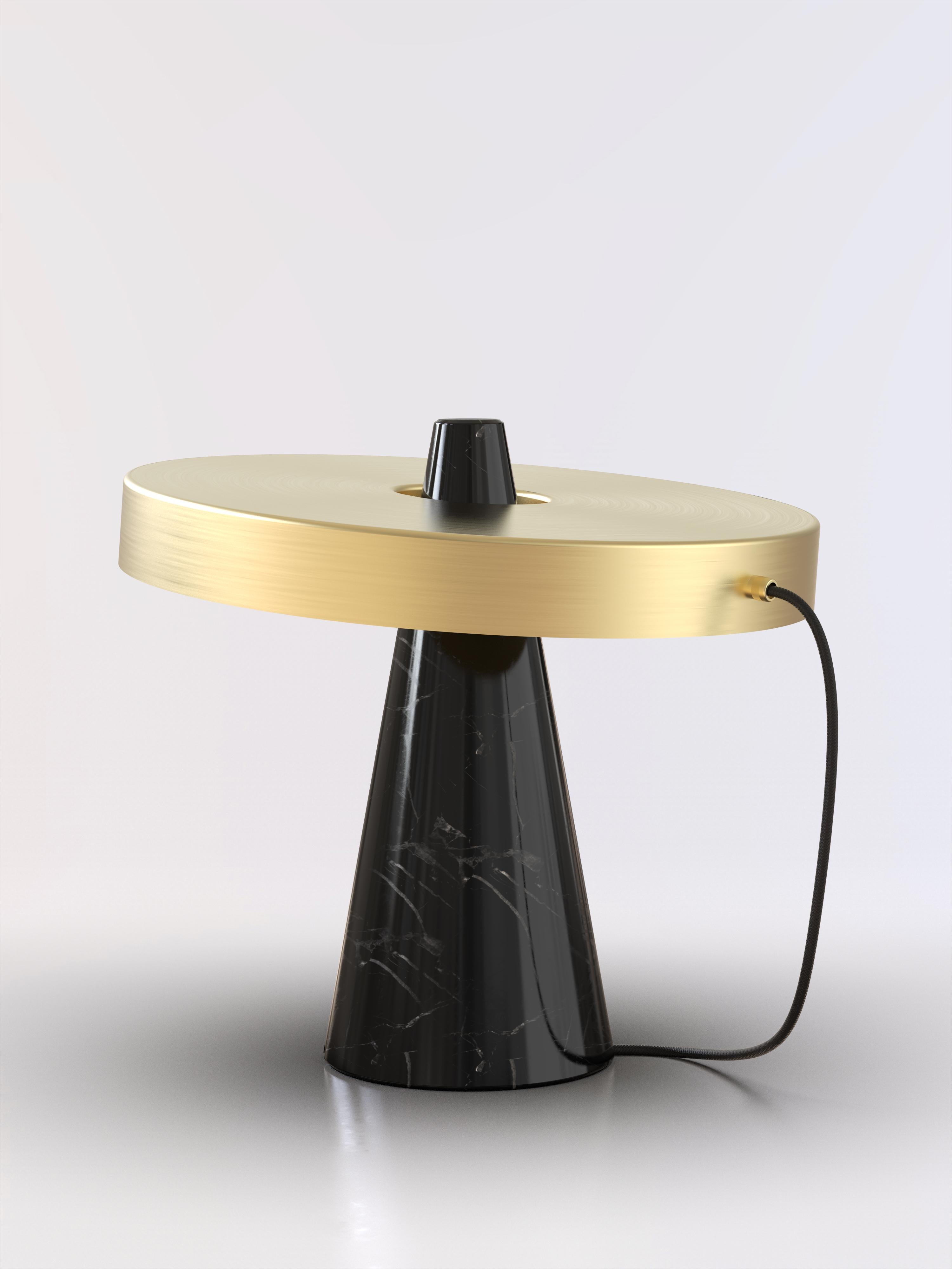 Table lamp with Marquinha black stone base and brushed brass lightshade.
The light shade is disconnected from the stone base and free to tilt, allowing multiple change of styles.