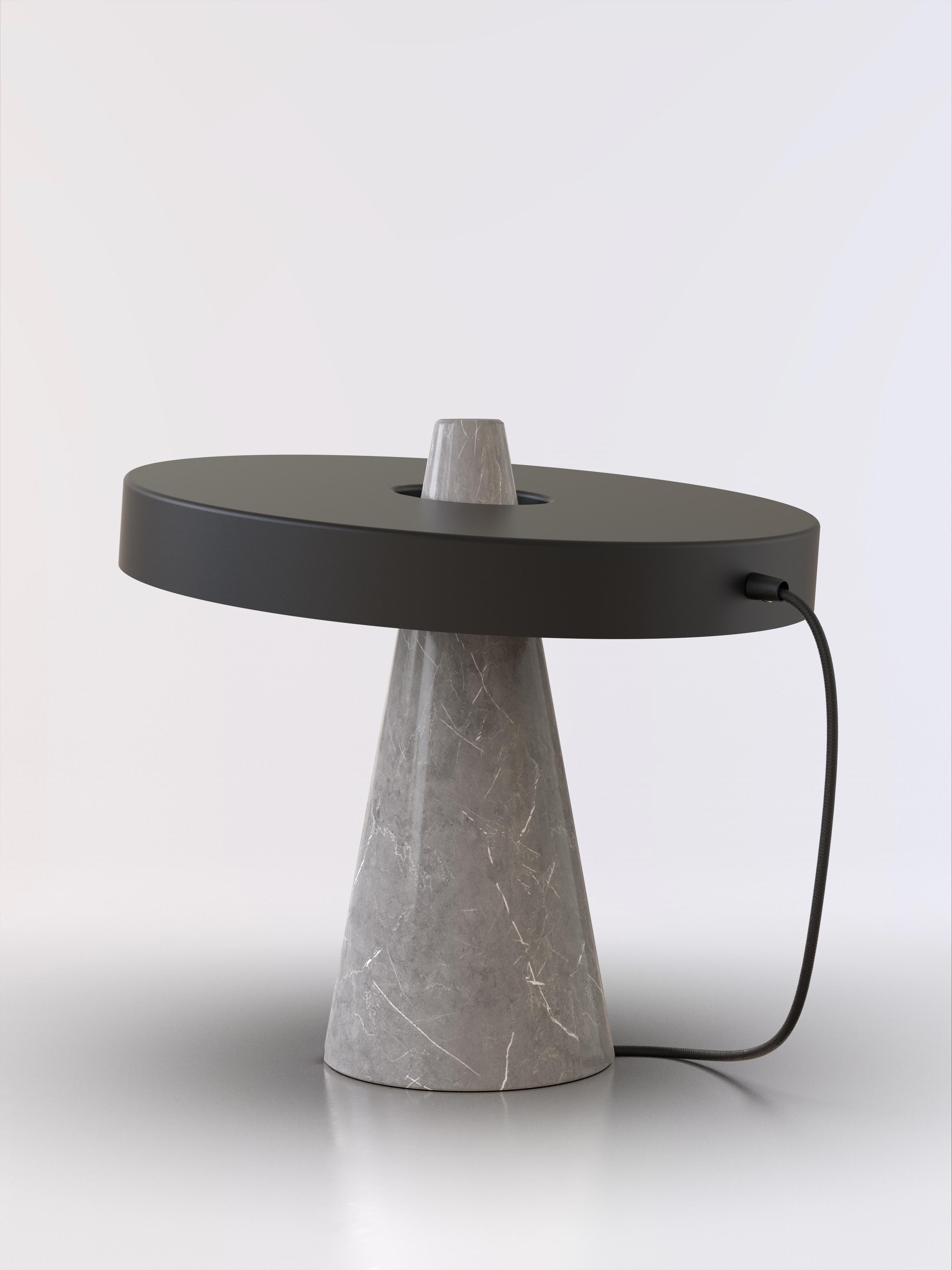Table lamp with grey stone base and black paint lightshade.
The light shade is disconnected from the stone base and free to tilt, allowing multiple change of styles.