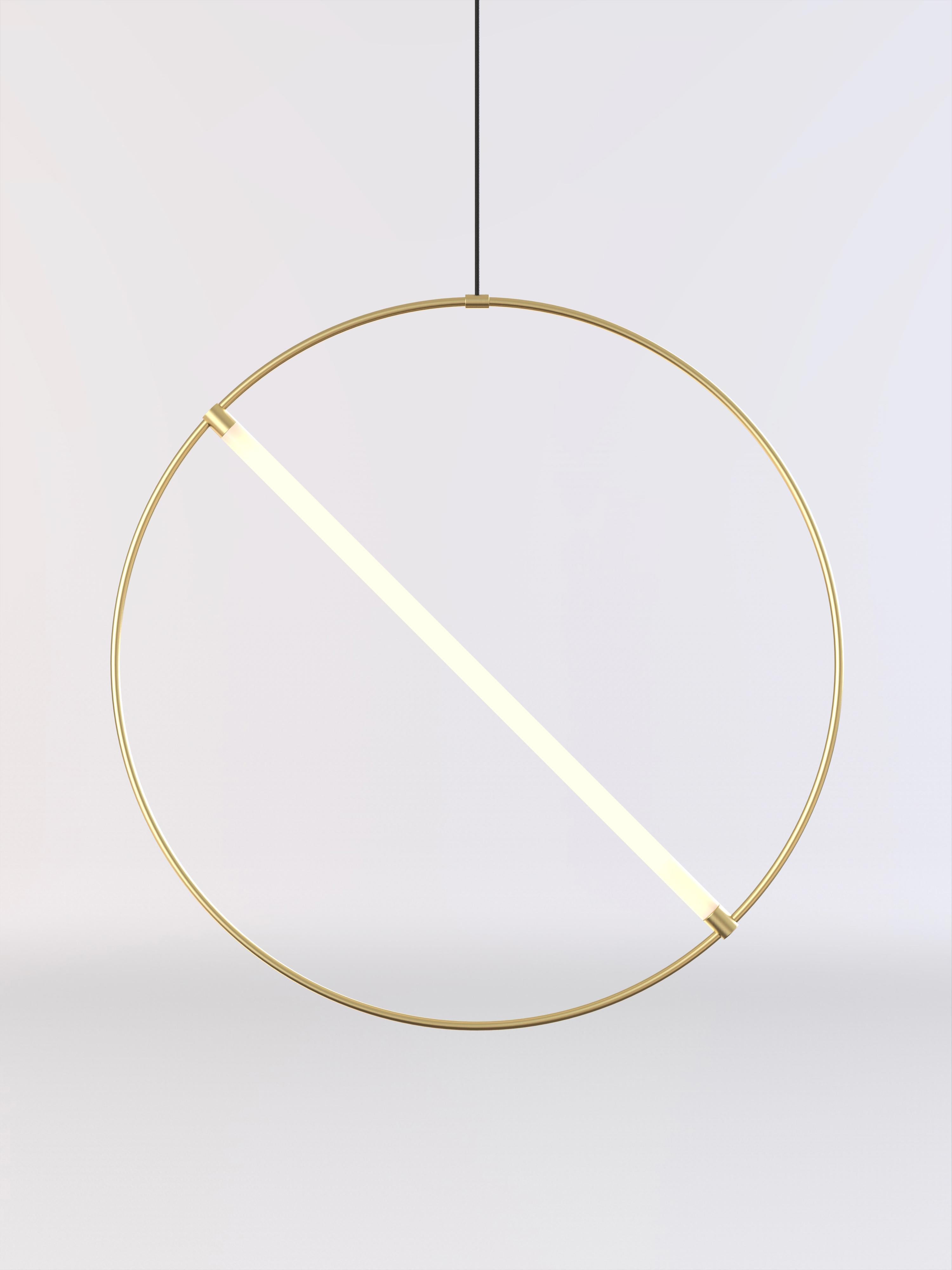 Ceiling lamp made by a brushed brass circular tube and a frosted light tube.