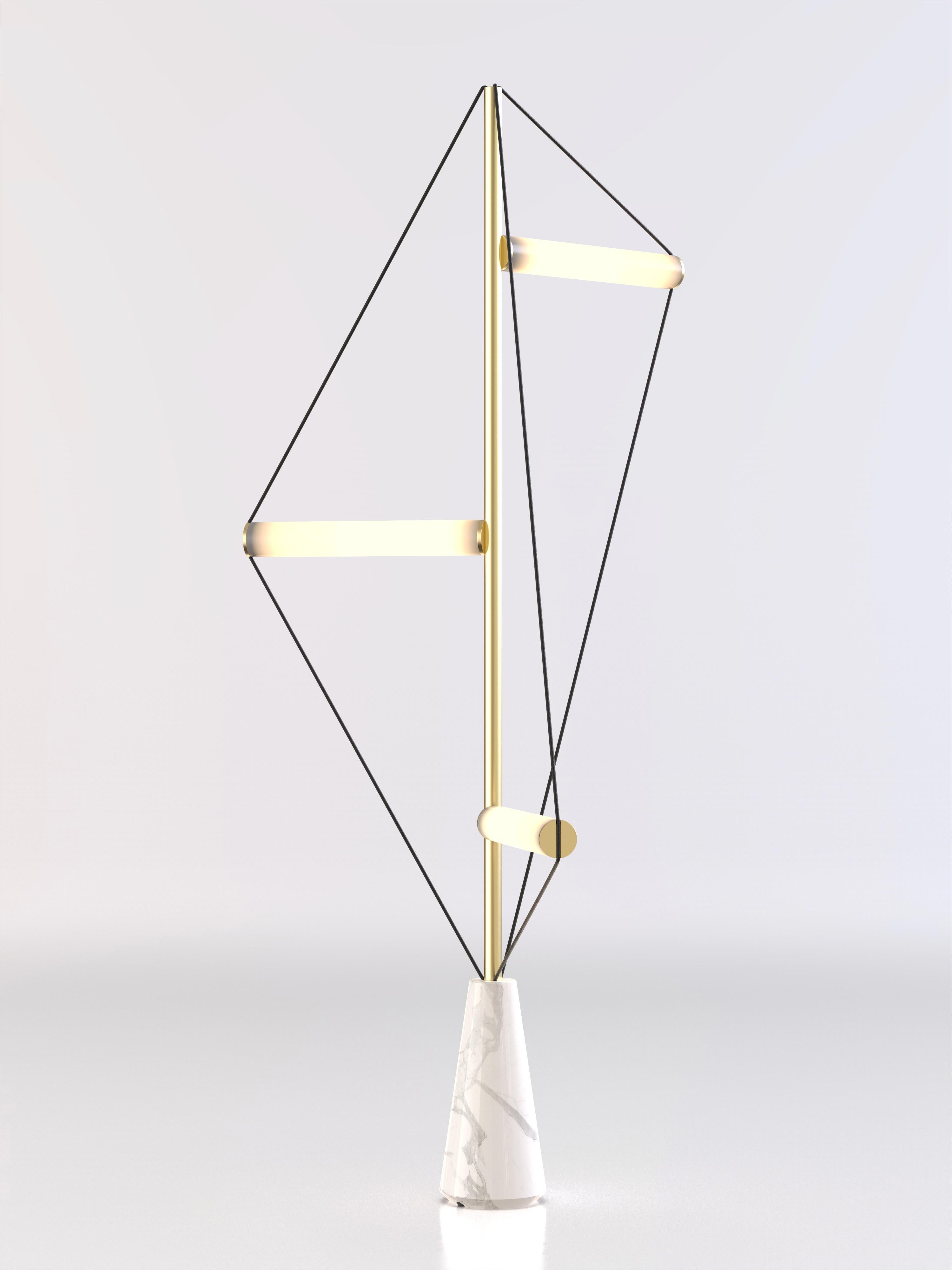 Floor lamp with Carrara white stone base, brushed brass structure and frosted light tubes.