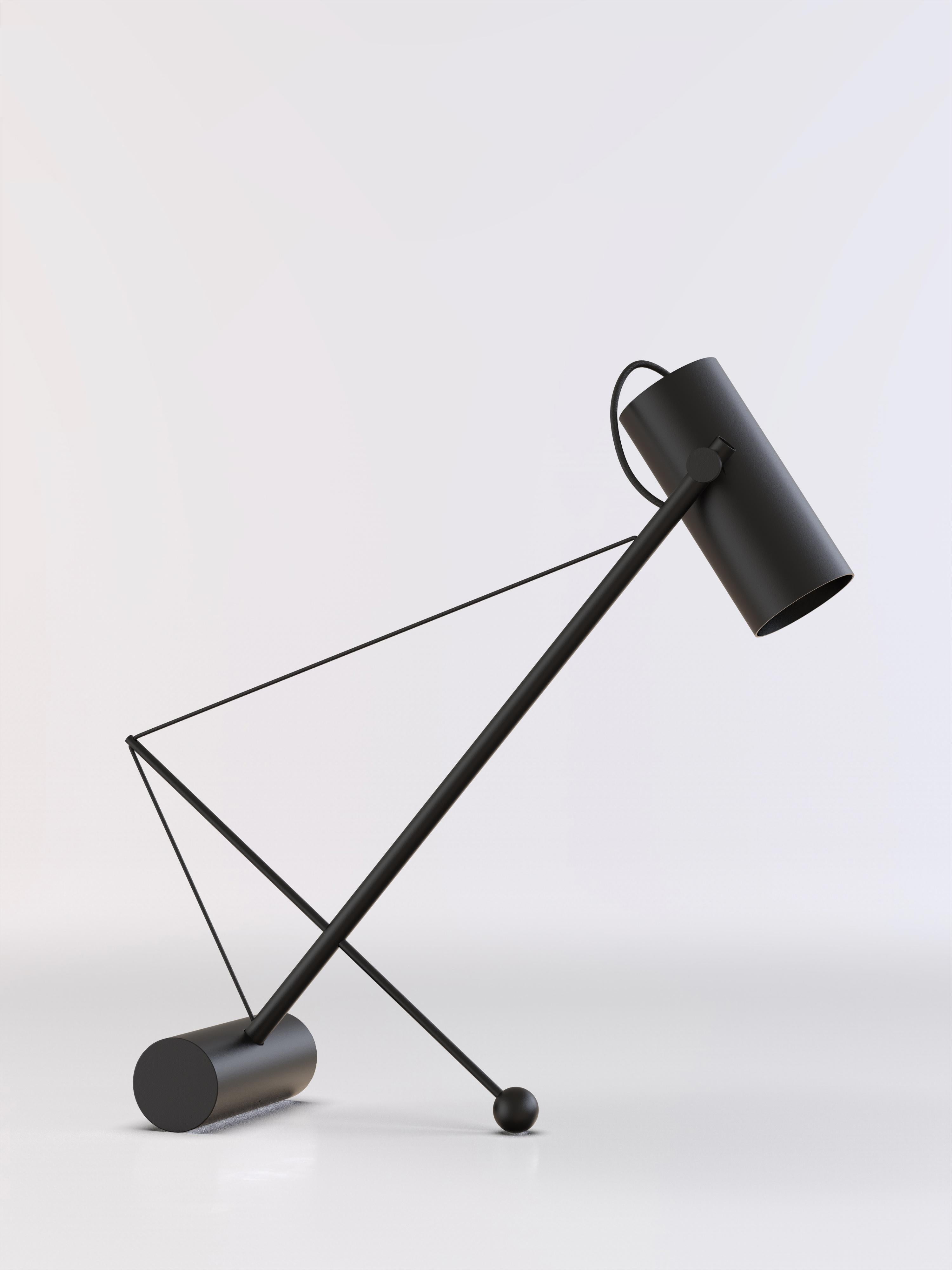 Reconfigurable table lamp with black paint structure.

Thanks to the elastic band the lamp can be titled at will.