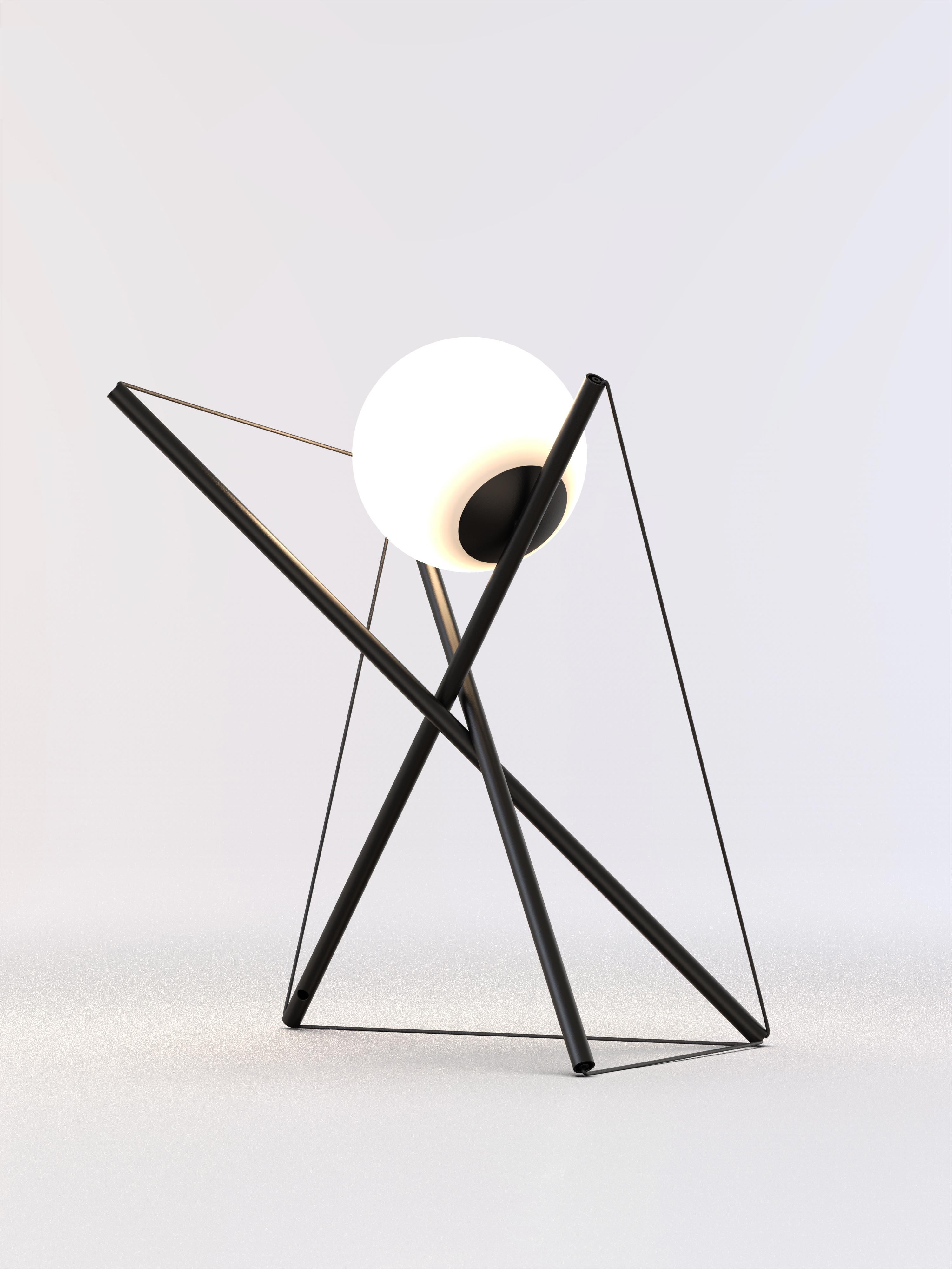 Table lamp with black paint structure and frosted light sphere.