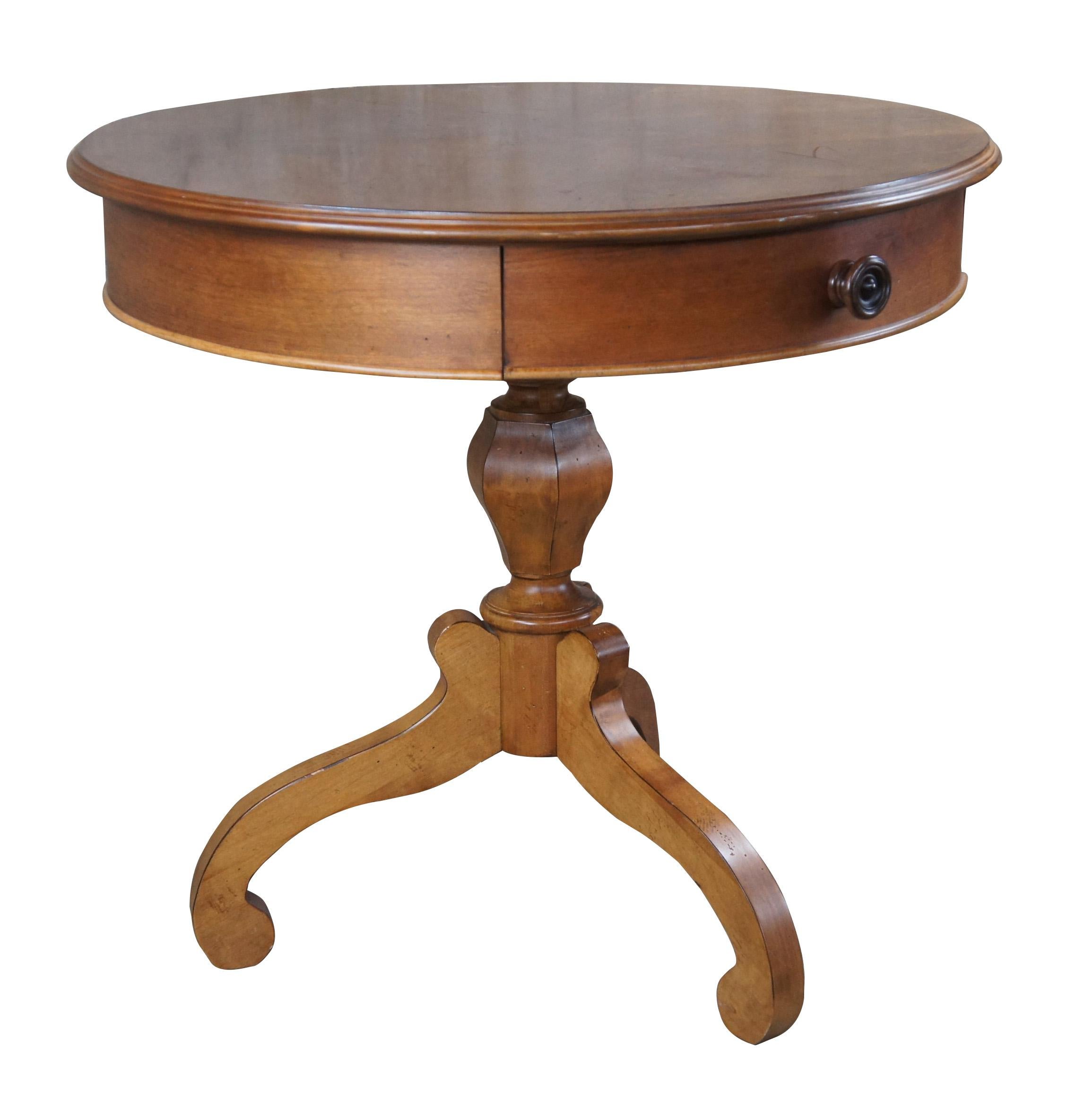 Vintage Eddie Bauer Lifestyles by Lane Furniture accent table.  Made of cherry featuring Empire styling with a round form centered by one drawer over turned baluster support scrolled feet.
 
307, 485-34, Made in USA.

Dimensions:
32