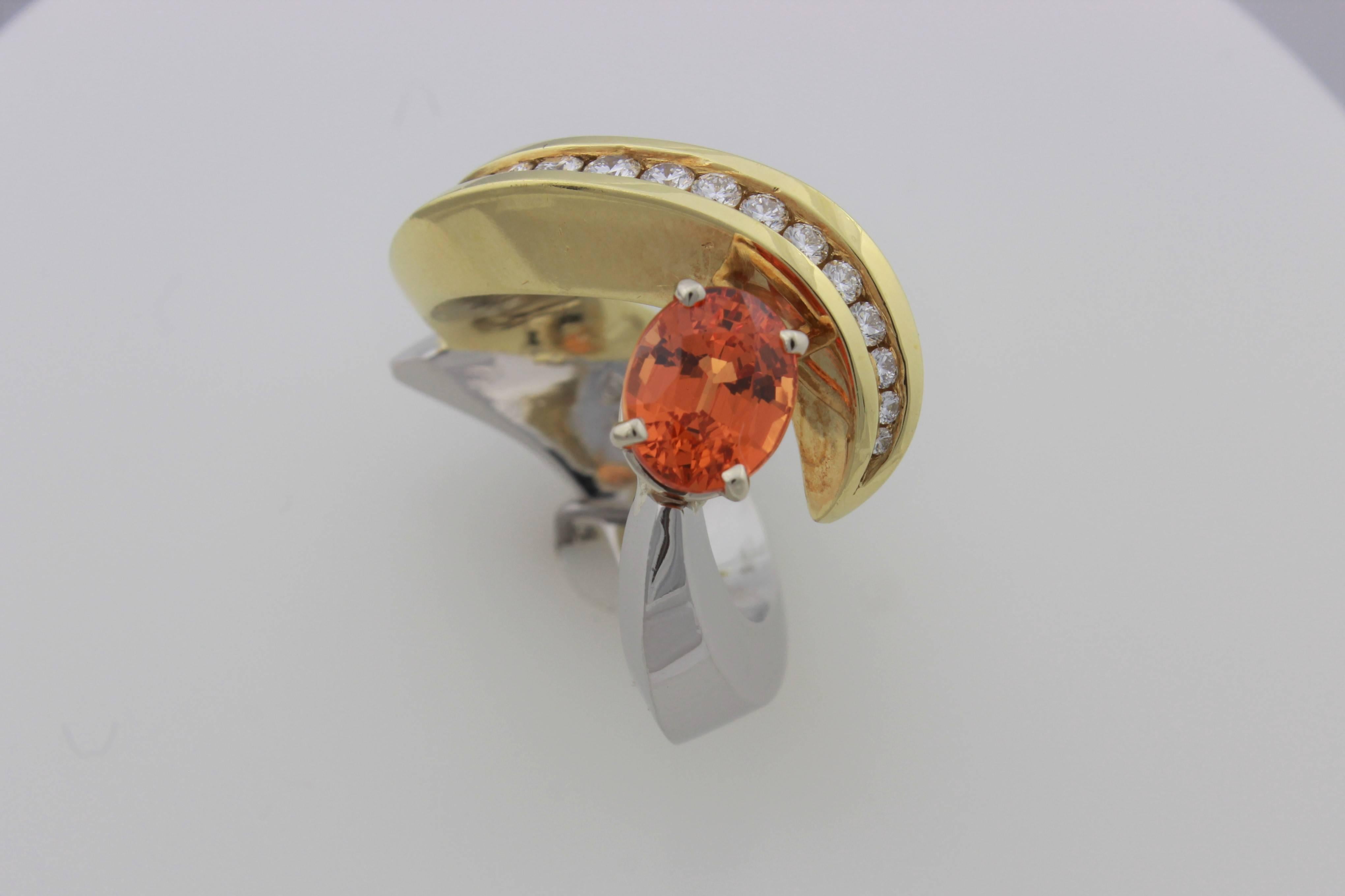 Eddie Sakamoto Designed Spessartite Garnet And Diamond Ring Set In Plat/18ktYG.  This sculpture of a ring contains a 2.17 carat oval Spessartite Garnet and 21 diamonds totaling .44 carats.  Finger size is 5.5, it is sizeable but tricky.