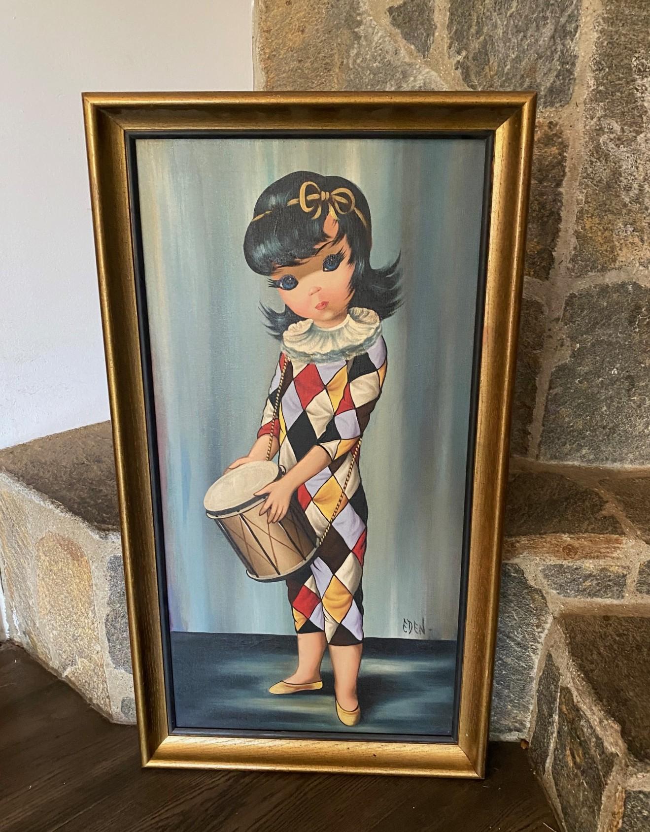 A wonderful and quite engaging original Big Eyes Harlequin Moppet oil on canvas painting by artist Eden.  This work features a young girl with piercing blue eyes dressed in a diamond-patterned costume. with a drum slung down from her shoulders. 