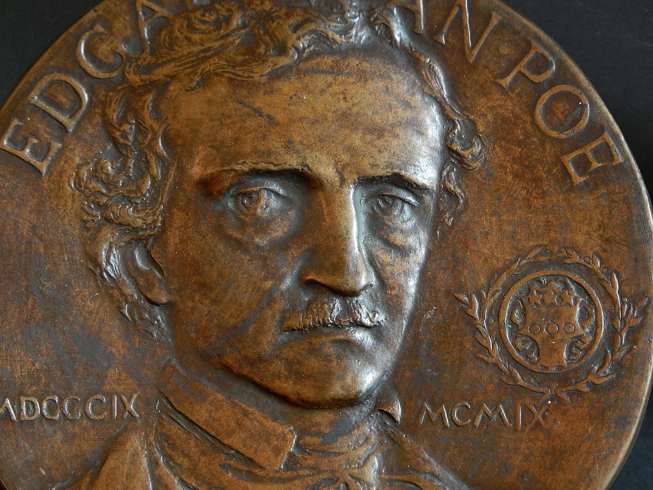 Rare and beautiful, this bronze portrait rondel, sculpted by Edith Woodman Burroughs, was issued by the Grolier Club in New York, and features the Club's armorial shield to the right. The bronze was created to commemorate the centennial of Poe's