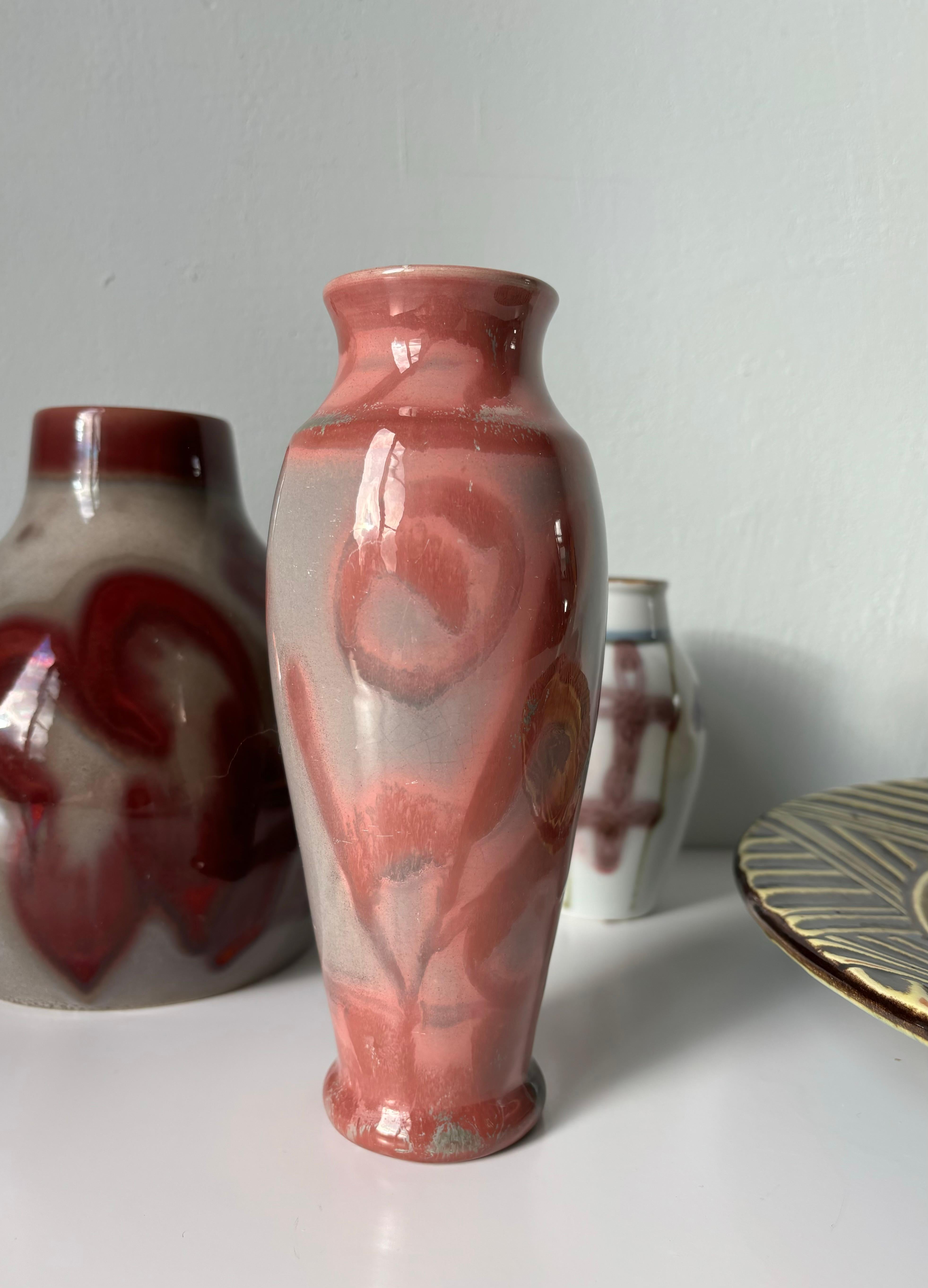100-year old Swedish Art Nouveau vase handmade by artist Edgar Böckman in the 1920s. Warm grey, rose, magenta colored lustre glaze covering the slender shape with large organic decorations. Signed under base. Beautiful antique piece in great vintage