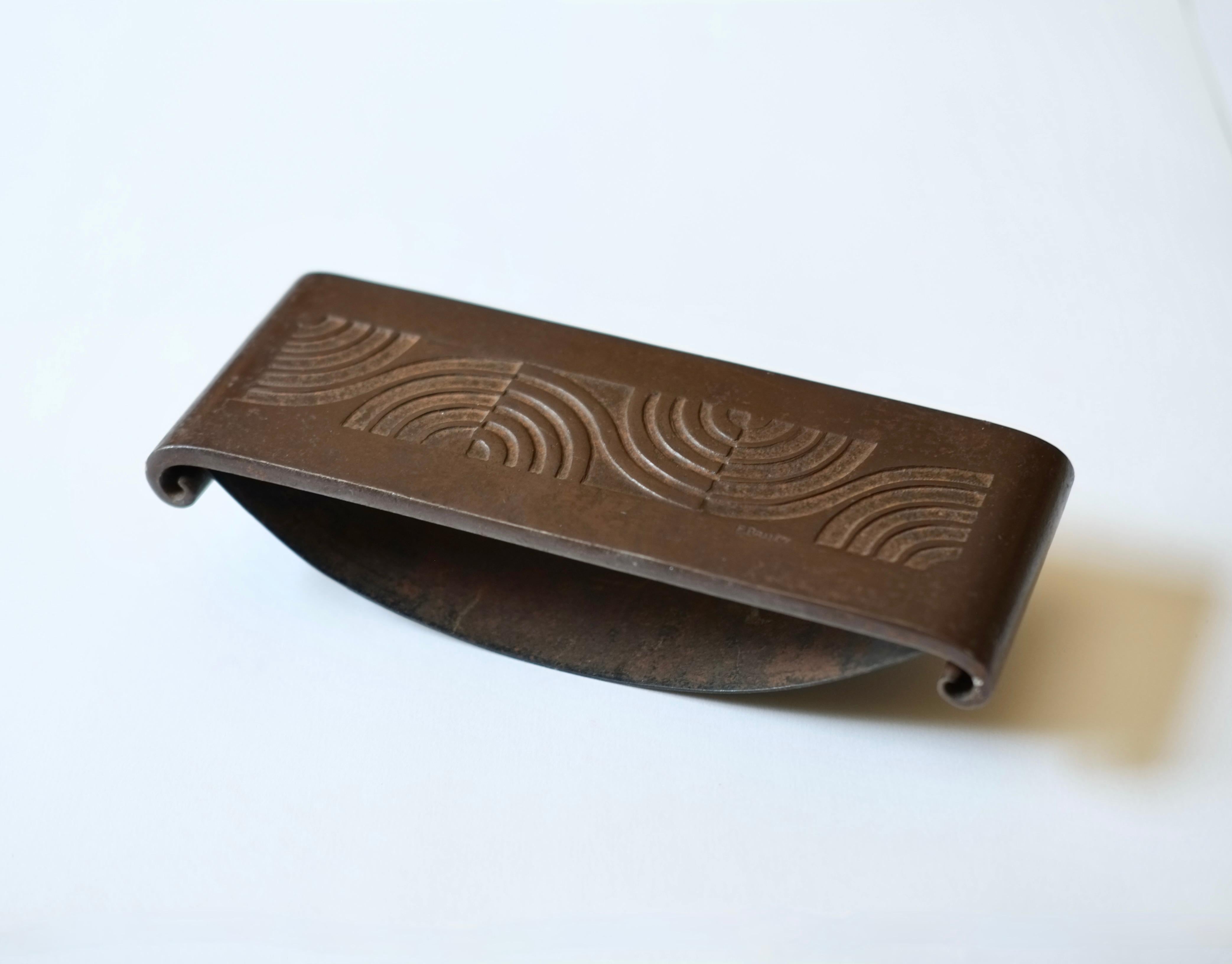 A decorative bronze writing case by legendary French Art Deco metal worker Edgar Brandt (1880-1960). 

Constructed of bronze and signed with a serial number verso. 

The case can be hung as a decorative item. 