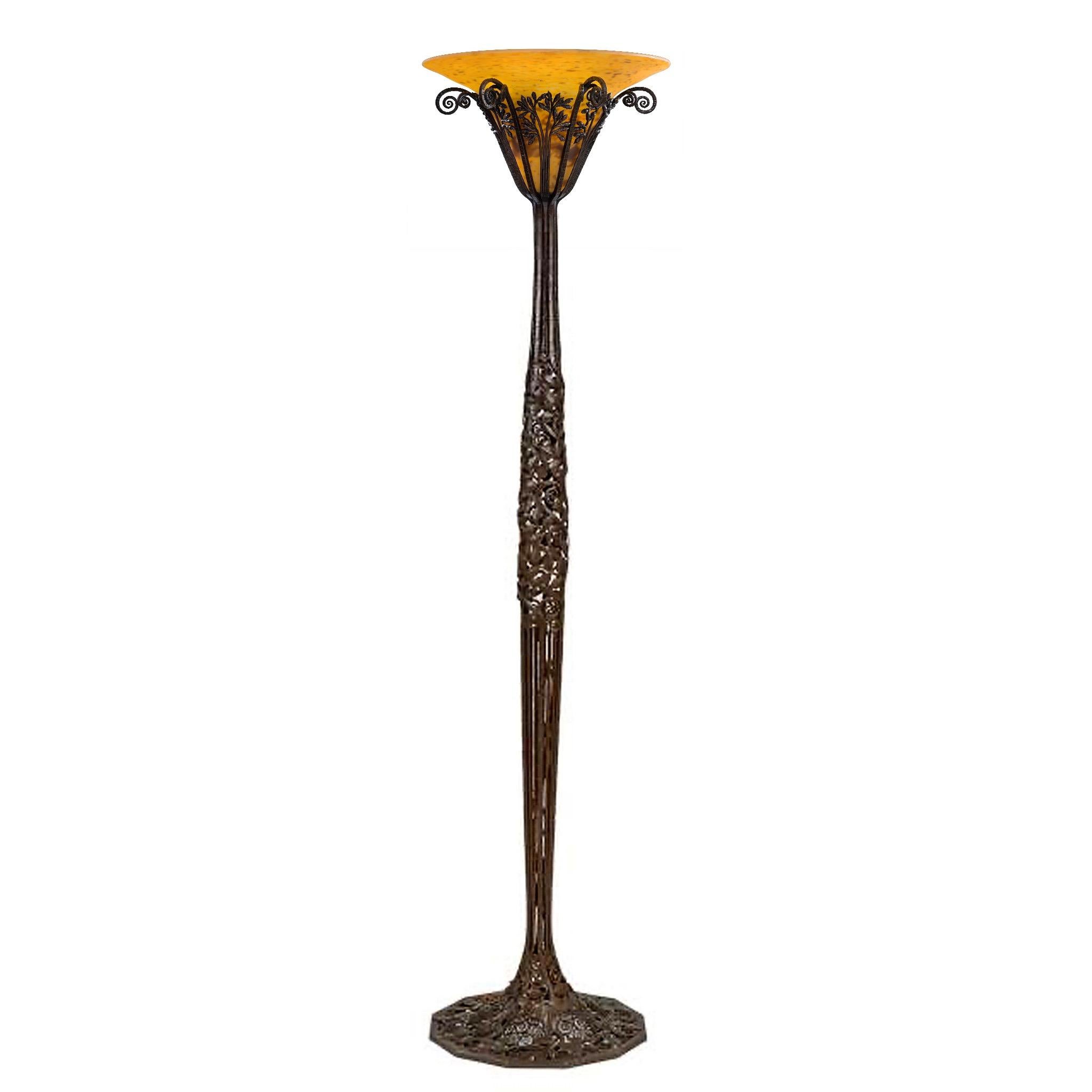 This wrought iron and glass “Les Roses” floor lamp by Edgar Brandt and Daum surprises and delights with its high Art Deco styling. A calyx of wild rose buds and stylized cabbage roses support an amber glass shade. Daum’s glass took inspiration from