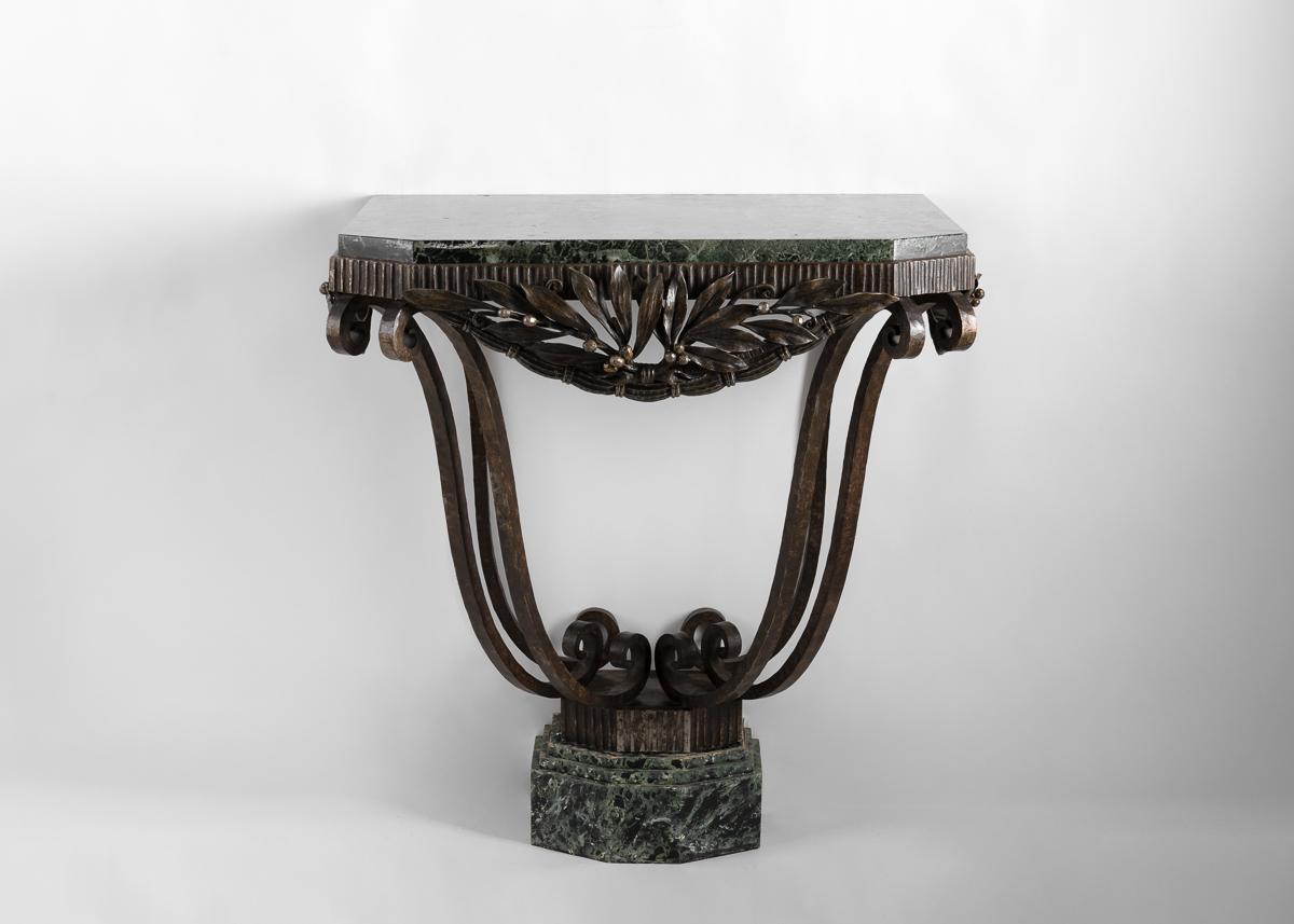 This supremely elegant piece boasts a carved, green marble top, and a delicately supple wrought iron base. With it's emphasis on natural motifs, and its incredibly detailed metalwork, the piece is distinctive of creator, one of the key exponents of