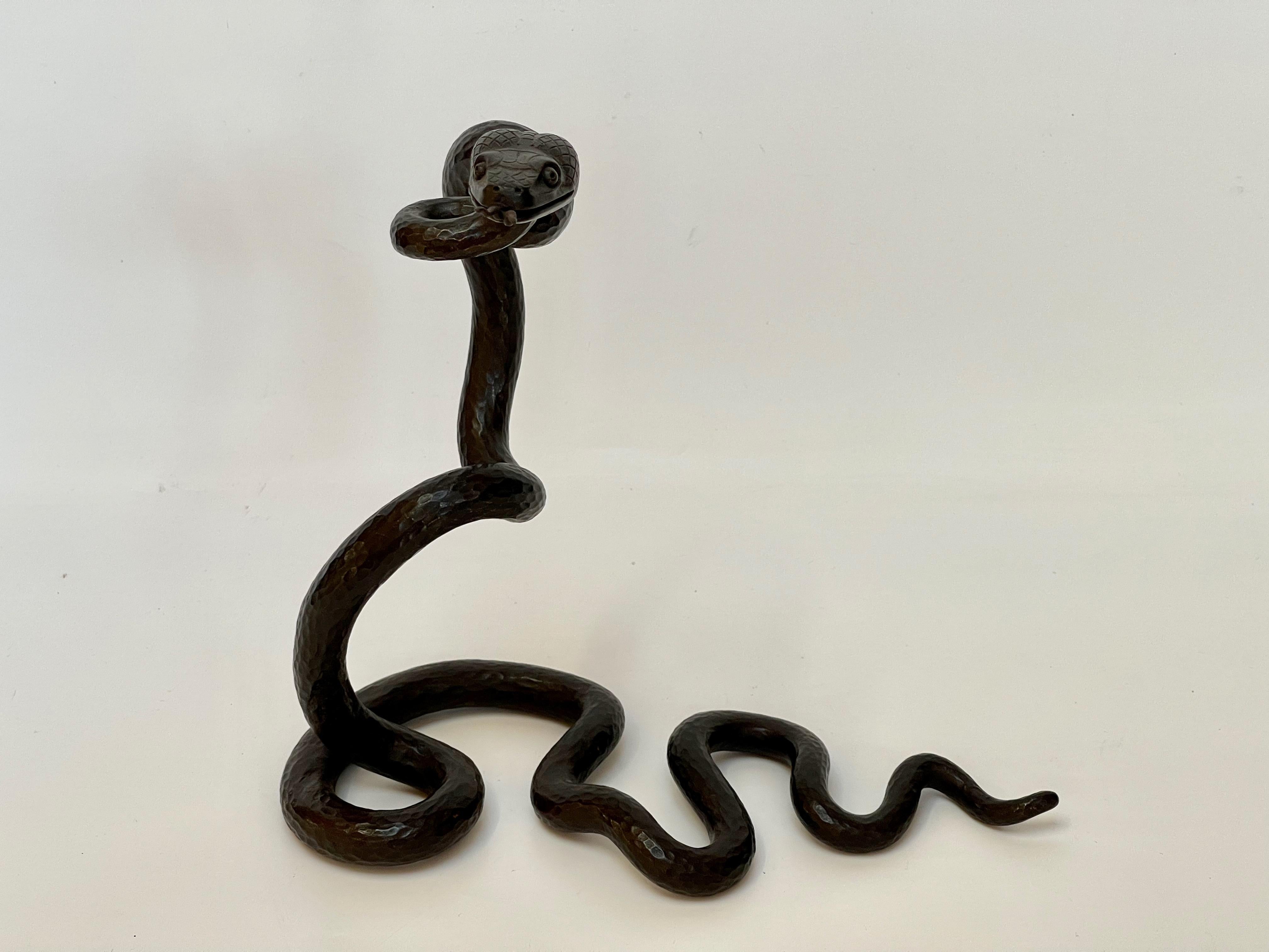 Art deco serpent in hammered wrought iron stamped Edgar Brandt. 
In very good shape.
Weight : 2,2 Kg
You can contact me for a shipping quote.
Edgar Brandt was born in Paris in 1880 and studied at the Vocational School of Vierzon.
In 1925, BRANDT
