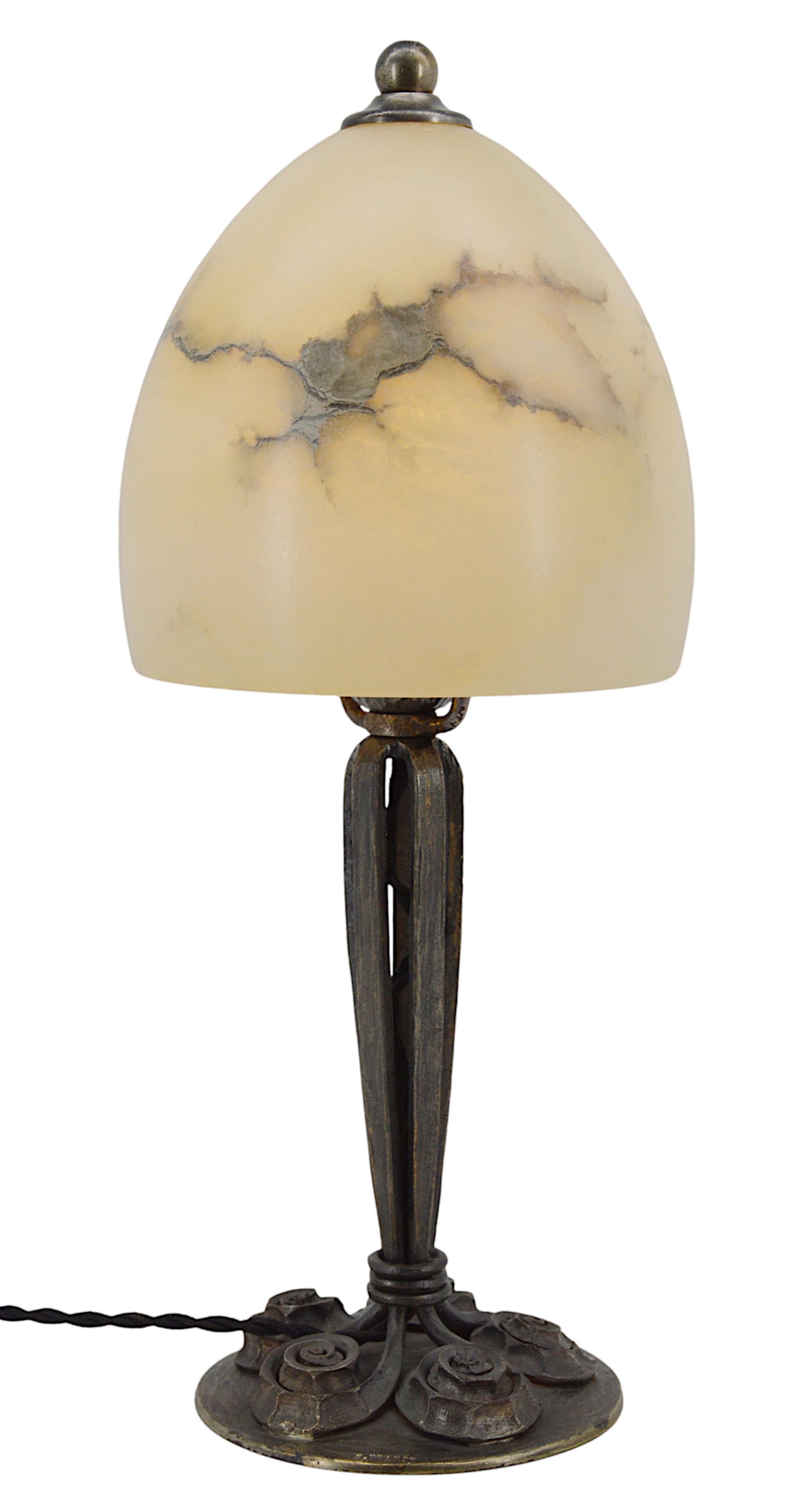 French Art Deco table lamp by Edgar BRANDT, France, 1920s. Wrought-iron base. Alabaster shade. Old alabaster cannot be compared to new ones. Old alabaster has veins. Sometimes they can be mistaken for cracks. But they are not cracks, they are veins.