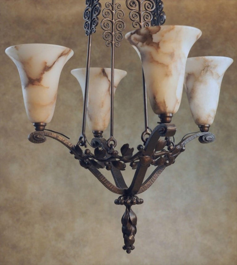Classic French Art Deco ceiling fixture by Edgar Brandt, circa 1922, in hand forged iron with alabaster shades.
