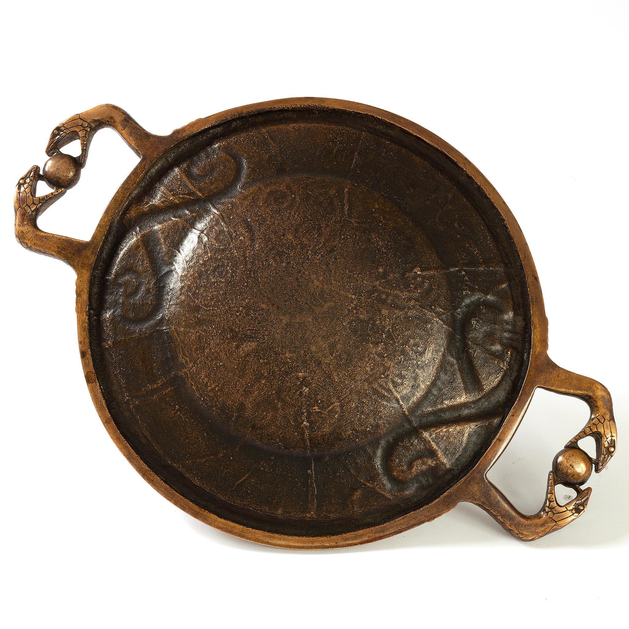 The form of this exquisite Edgar Brandt serpent tray was inspired by East Asian Bronze mirrors. In East Asian culture, mirrors were one of the most potent symbols of power, revered as sacred objects representing the gods. They were admired as