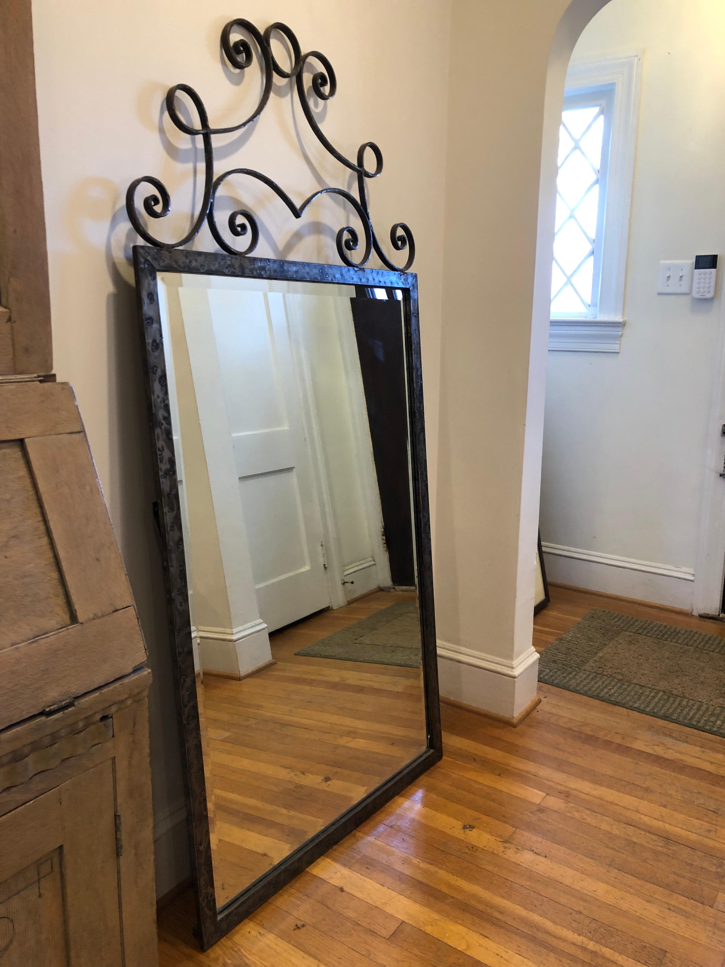 Large wall mirror in the style of Edgar Brandt.
Hand forged solid steel with hammered details. Beautiful curved deco detail along the top. 

Mirror has a beveled edge.