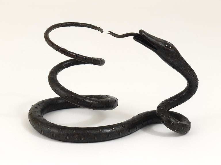 A wrought iron Art Nouveau era model of a snake / serpent. High-quality craftsmanship, handmade of forged iron by a Viennese metalworker in the 1920s.
A decorative object, which would look great in your shelf, but also suitable as a paperweight, a