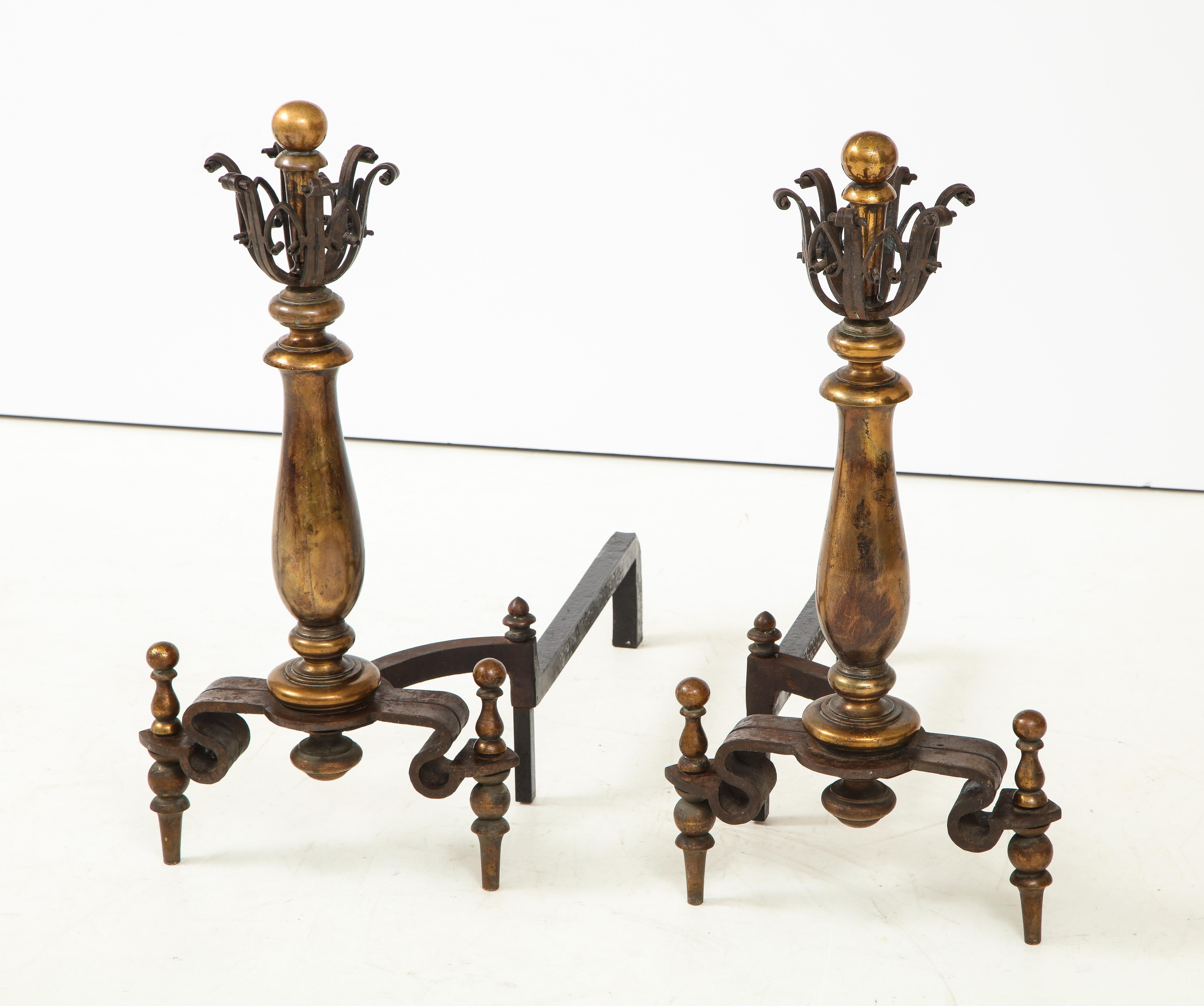 Pair of French Art Deco heavy iron and brass spindle andirons with hand wrought decorative trim.