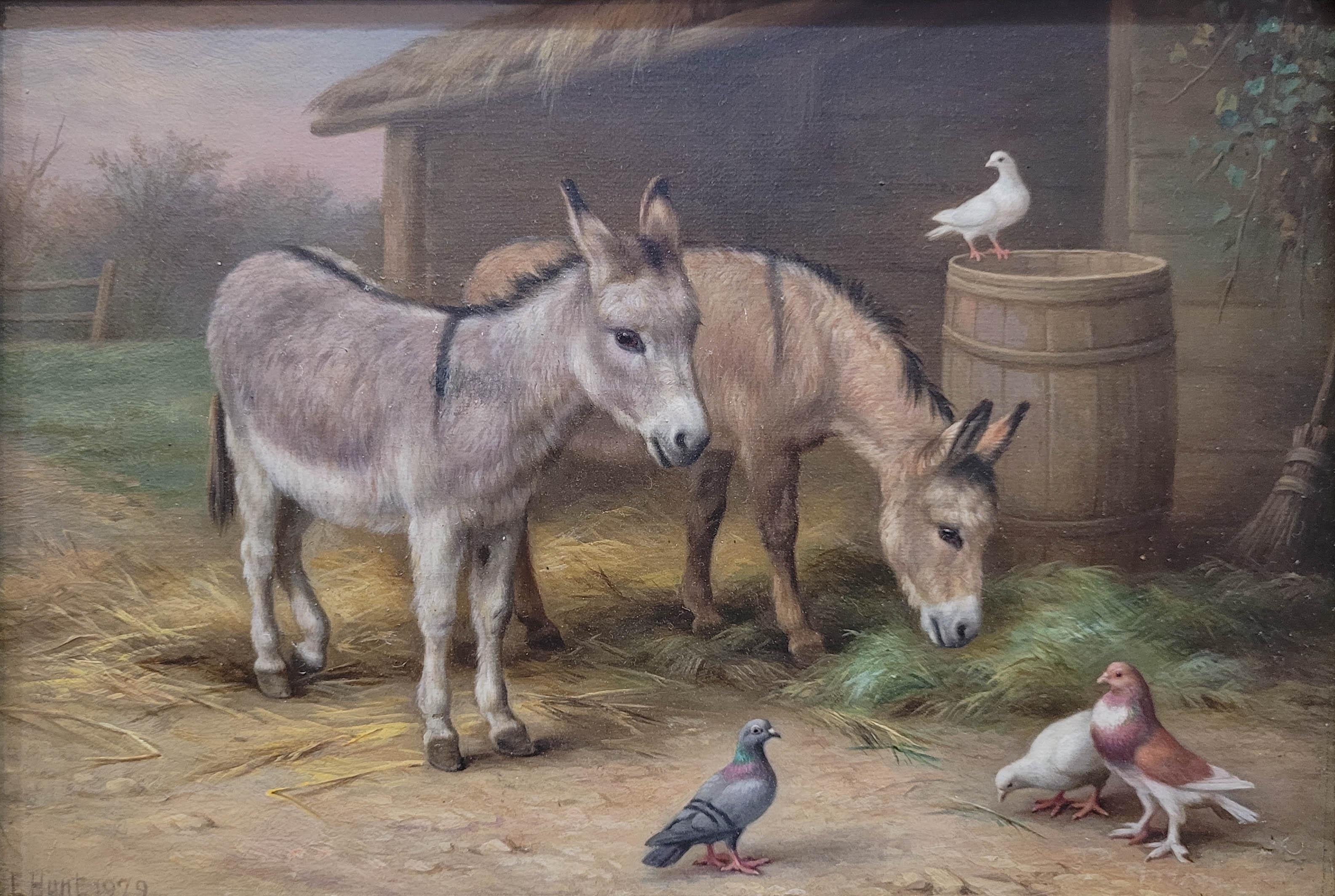 Esta encantadora pintura al óleo sobre lienzo, titulada Dos burros y palomas en el corral, capta un momento sereno de la vida rural con notable detalle y calidez. Atribuida al célebre pintor de animales británico Edgar Hunt (1876-1955), la obra
