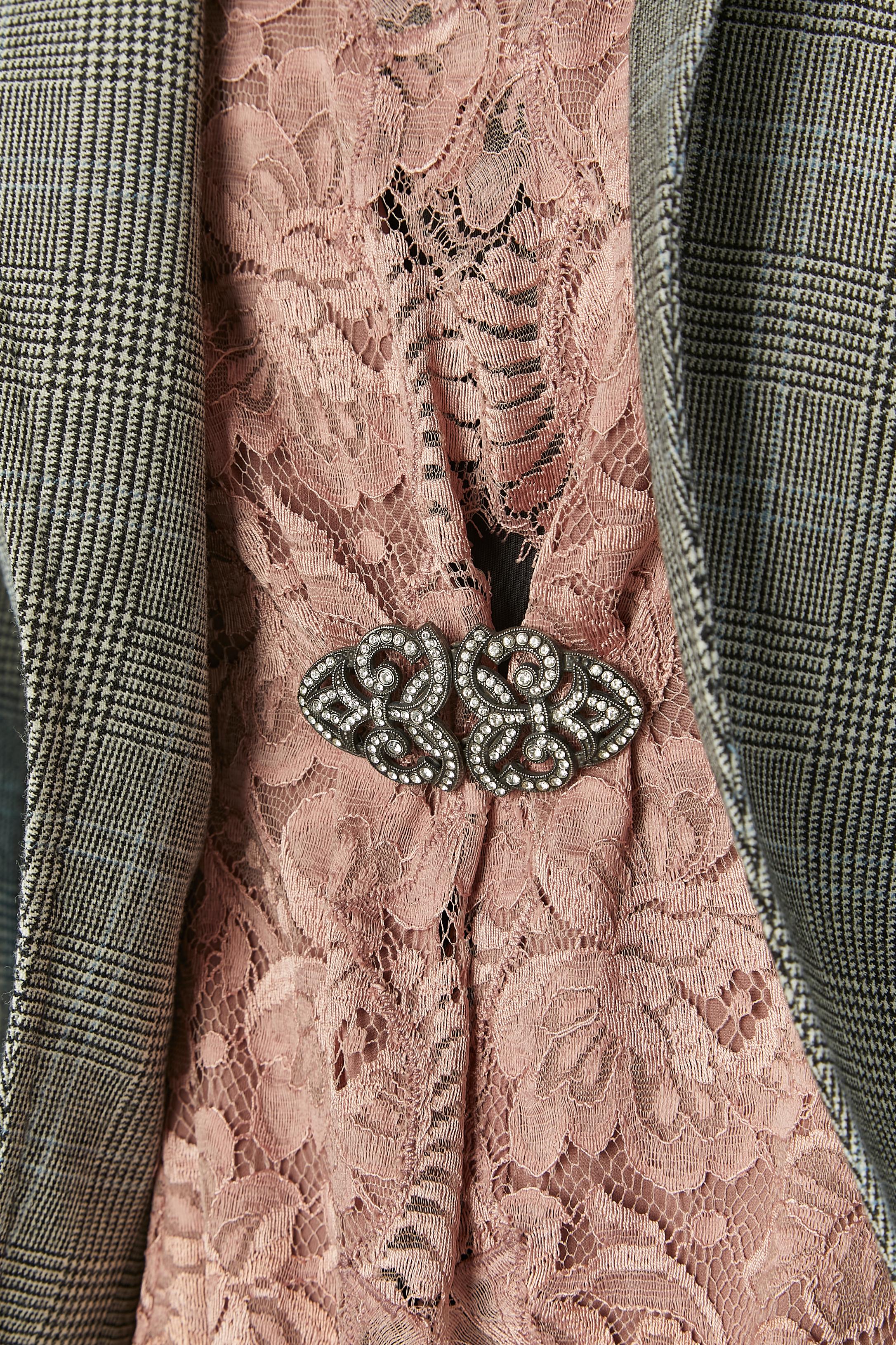 Edge to edge Prince de Galles jacket with pink lace. Main fabric composition: 70% wool, 18% polyamide, 12% rayon. Lining: 65% rayon, 35% cupro. No information regarding the lace composition but the is a chiffon lining underneath. 
Rhinestone brooch
