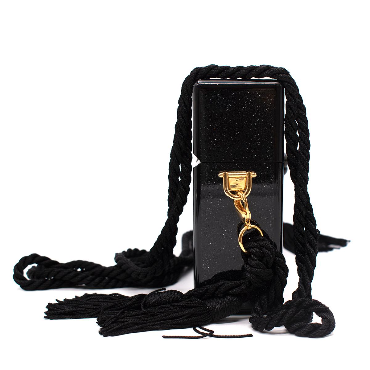 Edie Parker Black Small Trunk Stars Acrylic Bag

- Mirror effect inside 
- Gold and mirror stripe at the front 
- Star mirror details on the corner 
- Rope cross-body strap 
- Tassels on the strap
- Clasp fastening at centre 
- Dust bag included