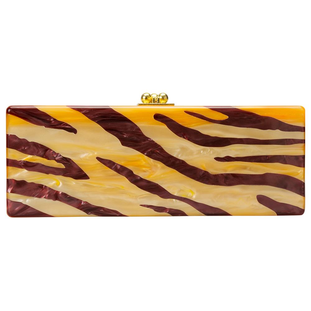 Quirky, trendy and very stylish, this clutch from Edie Parker is crafted from acrylic and features a boxy silhouette. It is styled with a tiger stripe print on one side. This clutch opens to a roomy interior that is spacious enough to store all your