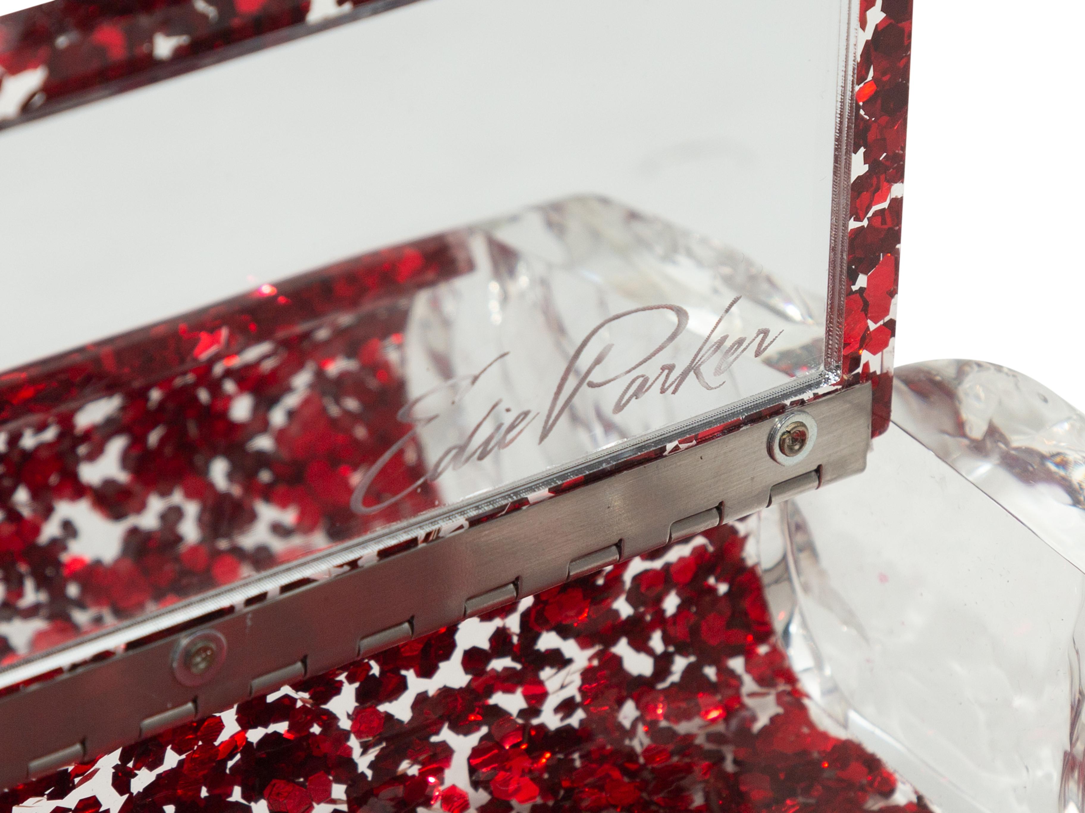 Product details: Red & Transluscent Edie Parker Lara Lucite Clutch. This bag features a lucite body, silver-tone hardware, and a front clasp closure. 8