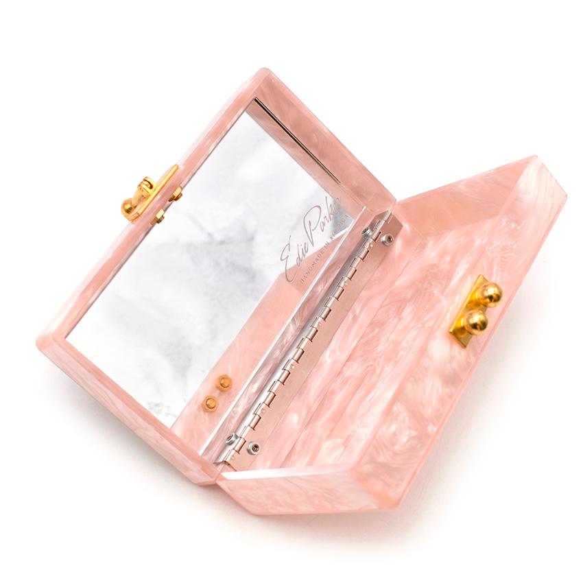 Edie Parker Rose Quartz Jean Clutch

A small Edie Parker clutch in shimmering, hand-poured acrylic. 
Polished gold tone kiss-lock clasp and hinge construction. The unlined interior has an inset vanity mirror, and is large enough to fit an iPhone 7+.
