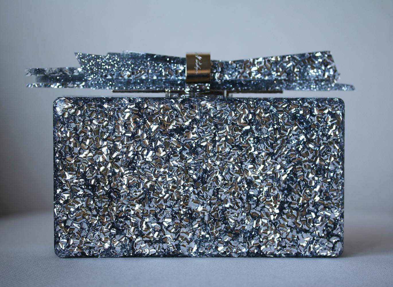 Edie Parker's 'Wolf' clutch is a glamorous accent to evening outfits, as proven by founder Brett Heyman at Harper's BAZAAR's 150th anniversary party. It's hand-poured from silver glittered acrylic and topped with a statement clasp that resembles