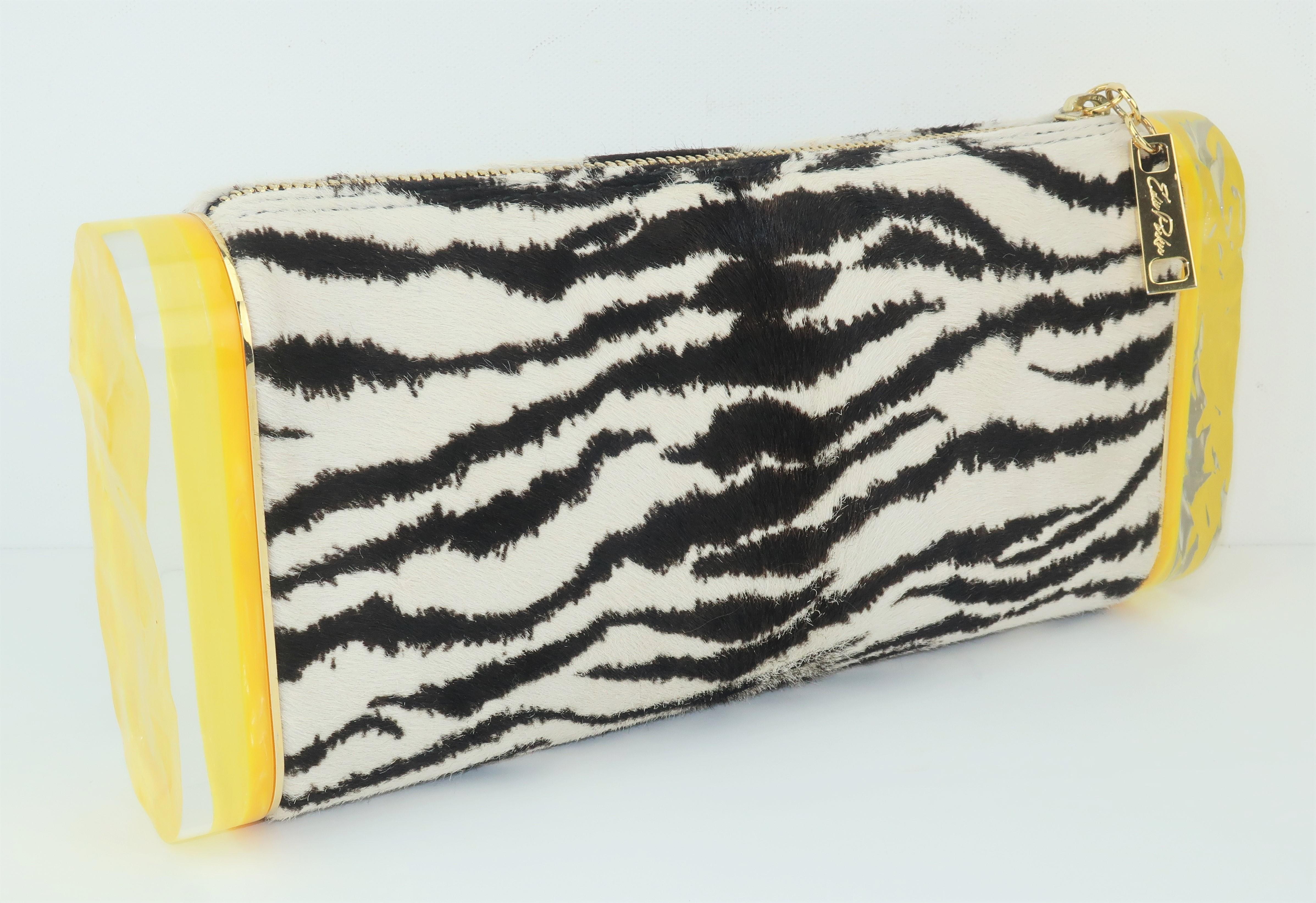 Edie Parker's designs by Brett Heyman are inspired by mid century fashions and each handbag is a unique and whimsical treasure.  This clever clutch is called the 'Lara' and features a zebra printed calf hair body accented by chunky acrylic pieces on