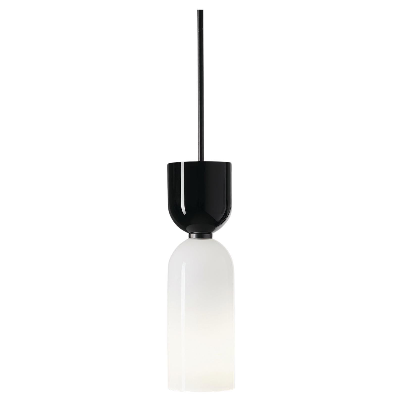 The Edie Pendant pairs two similar forms in hand-blown glass.

Pure shapes, geometry, rhythm and repetition create a harmonious whole when used in multiple, or a streamlined statement when used solo. A contrasting black-and-white color scheme